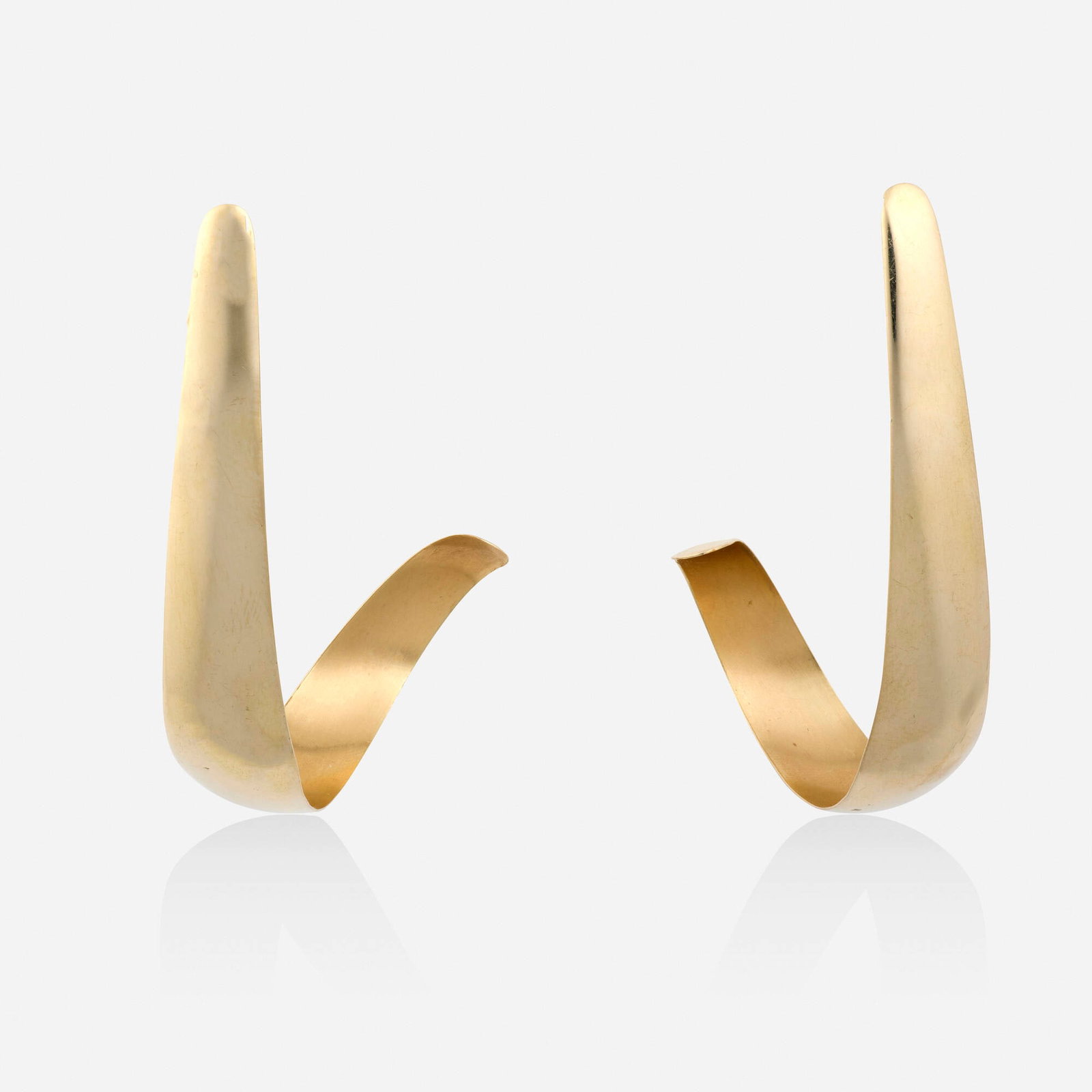 Daunis, Gold earrings: Daunis Gold earrings Of curved design 14k yellow gold Signed Daunis 2.50 x 0.375 in; Gross weight 5.7 dwts This work will ship from Lambertville, New Jersey.