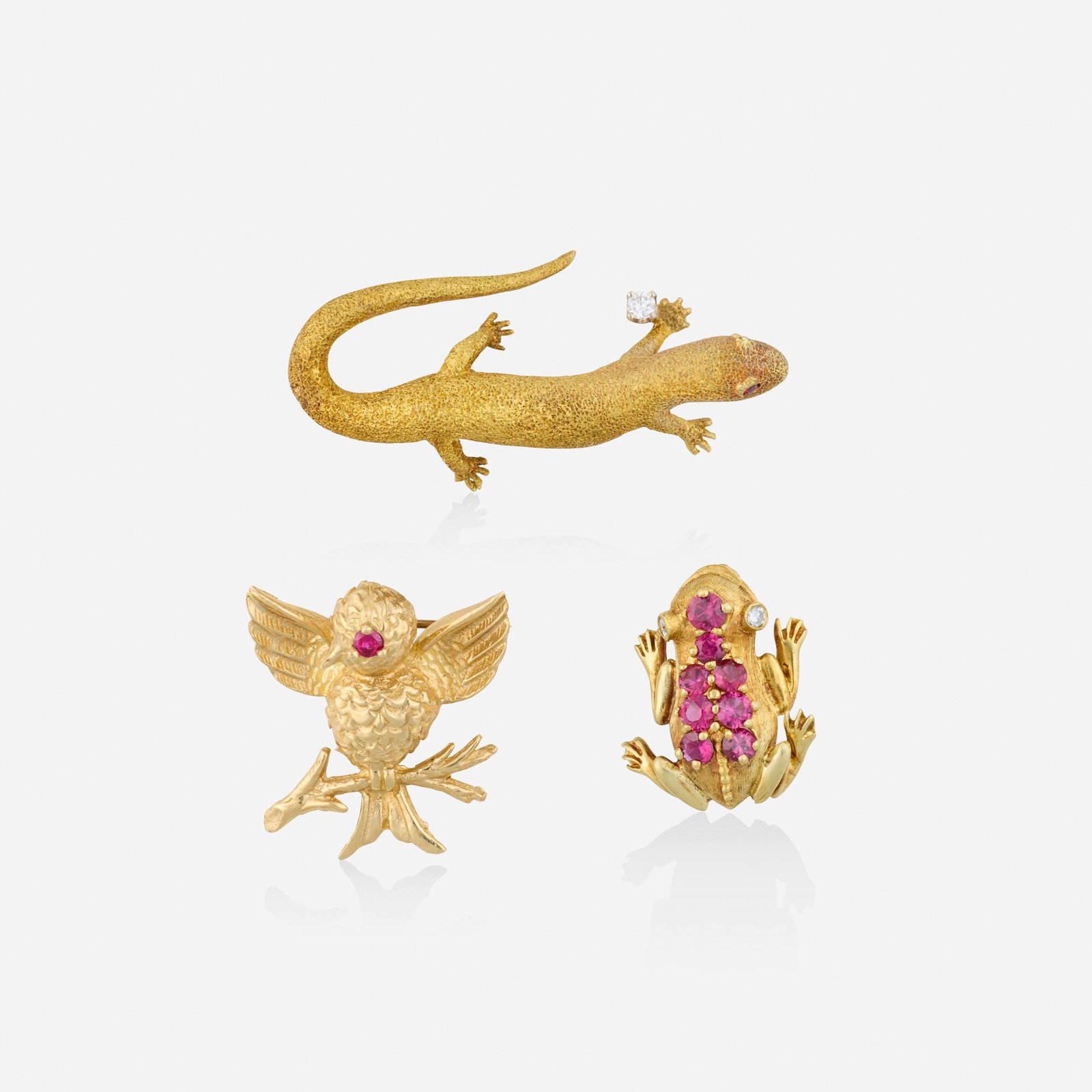 Group of ruby, diamond, and gold brooches: Group of ruby, diamond, and gold brooches Comprising three brooches, one a salamander with circular-cut ruby eyes and round brilliant-cut diamond; one a bird with circular-cut ruby eye; and one a frog