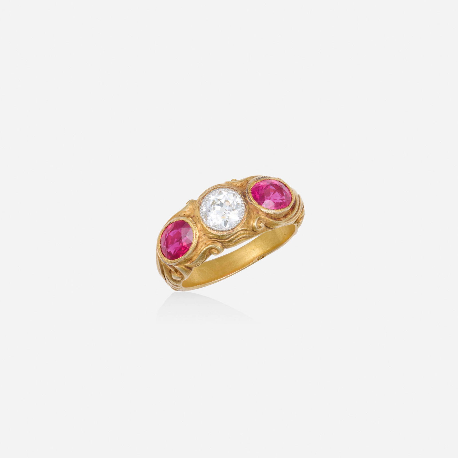 Diamond, synthetic ruby, and gold ring: Diamond, synthetic ruby, and gold ring Of scrolling design, set with an old European-cut diamond and oval-cut synthetic rubies Yellow gold Ring size 9.25-9.50; Gross weight 6.5 dwts This work will shi