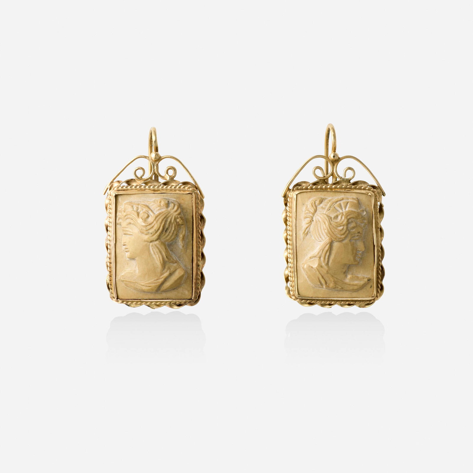 Lava cameo and gold earrings: Lava cameo and gold earrings Each set with a carved lava cameo framed by roped gold 14k yellow gold 1.125 x 0.625 in; Gross weight 4.8 dwts This work will ship from Lambertville, New Jersey.