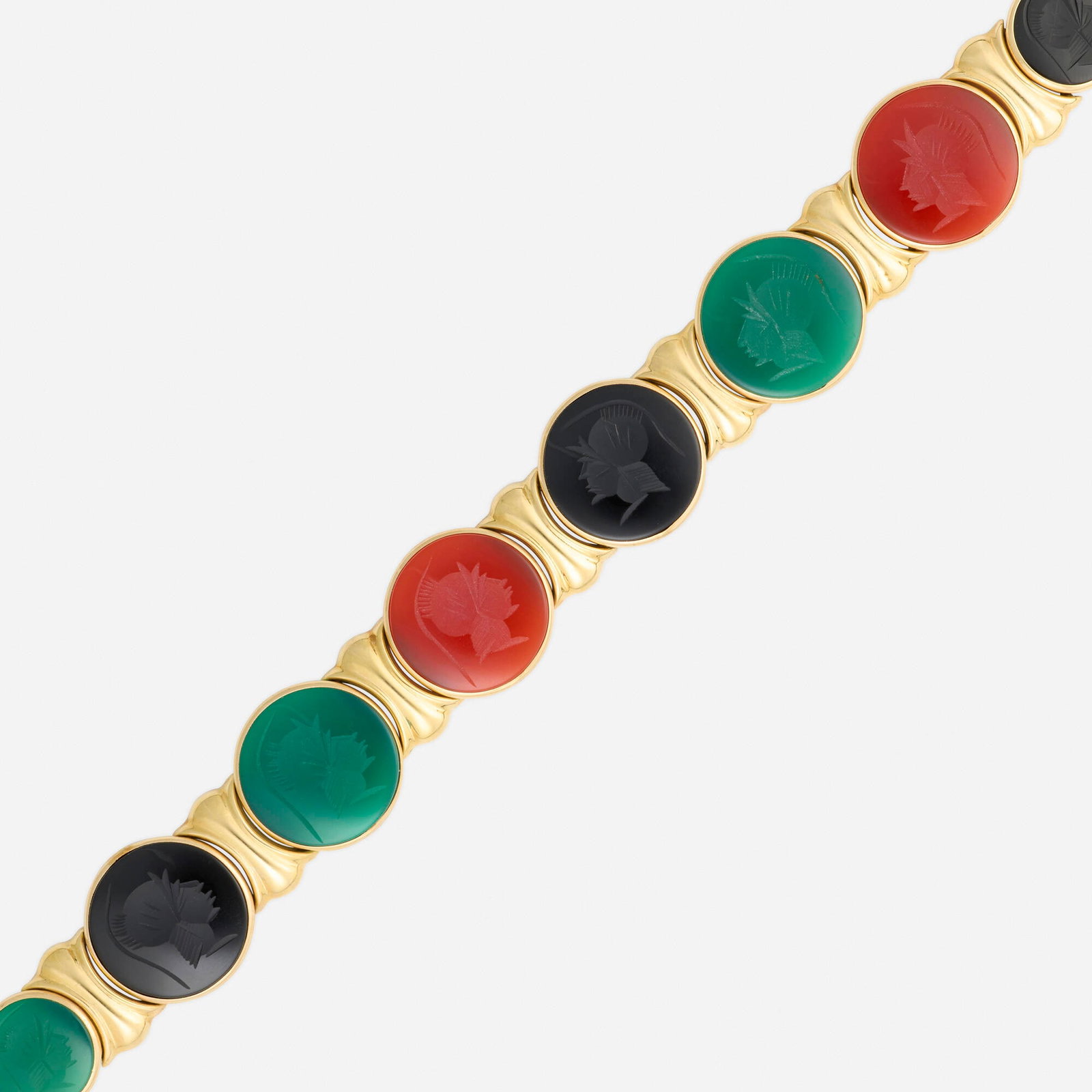 Multi-gem and gold bracelet: Multi-gem and gold bracelet Set with carved intaglios of dyed green chalcedony, black onyx, and carnelian 14k yellow gold 7.375 x 0.75 in; Gross weight 15.9 dwts This work will ship from Lambertville,
