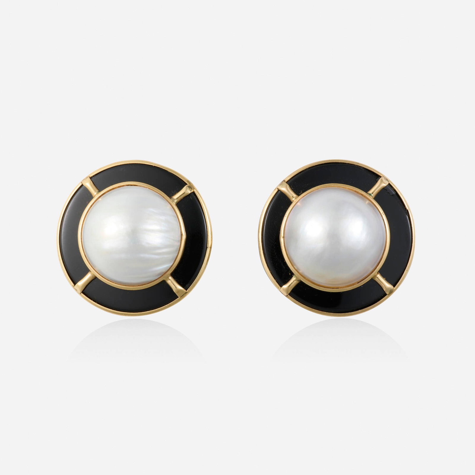 Black onyx, mabe pearl, and gold earrings: Black onyx, mabe pearl, and gold earrings Each set with a plaque of black onyx and mabe pearl 14k yellow gold 1 in; Gross weight 9.1 dwts This work will ship from Lambertville, New Jersey.