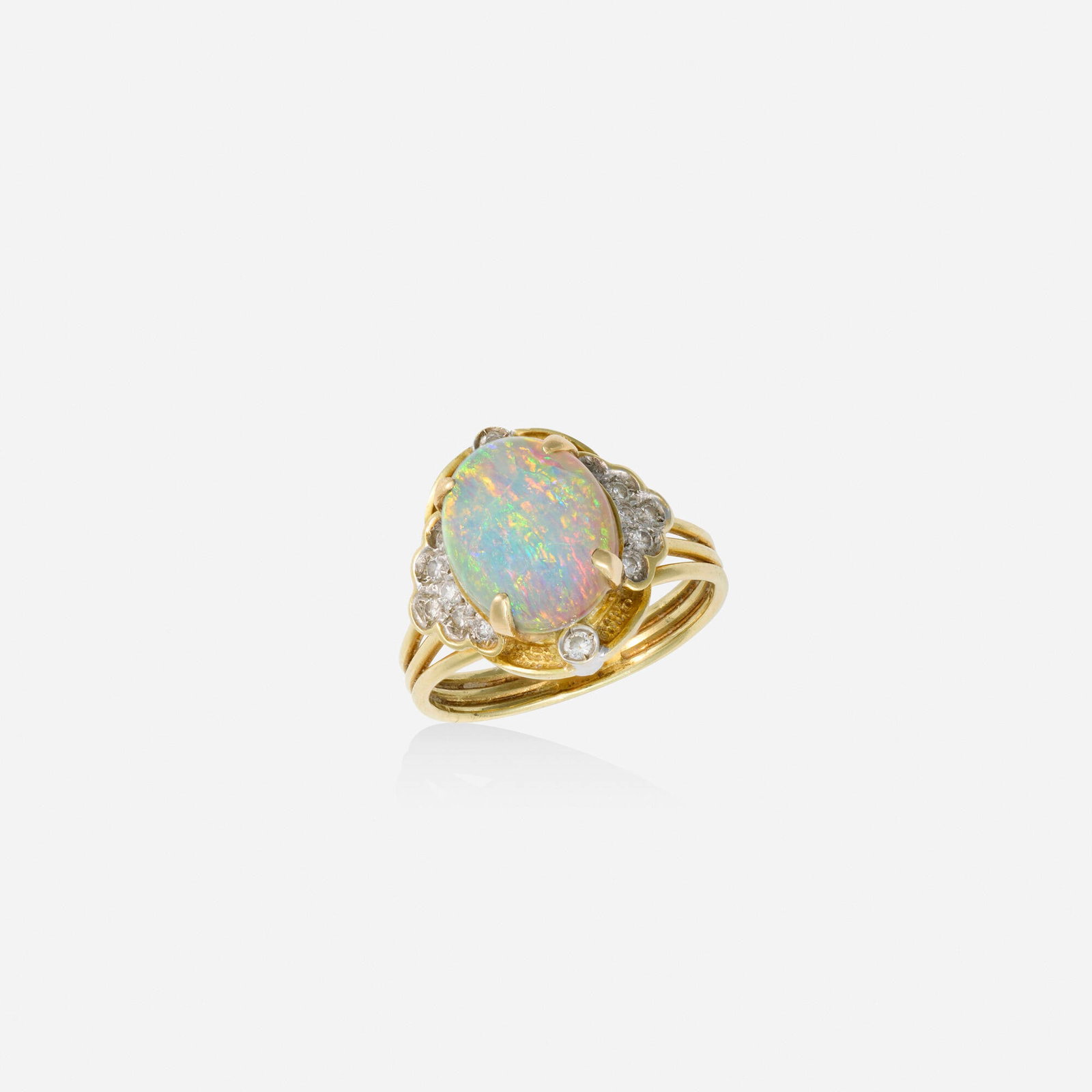 Opal, diamond, and gold ring: Opal, diamond, and gold ring Lori Ulanova was one of the first female violinists in the Los Angeles Philharmonic Set with a cabochon opal, framed by round brilliant-cut diamonds 14k yellow and white g