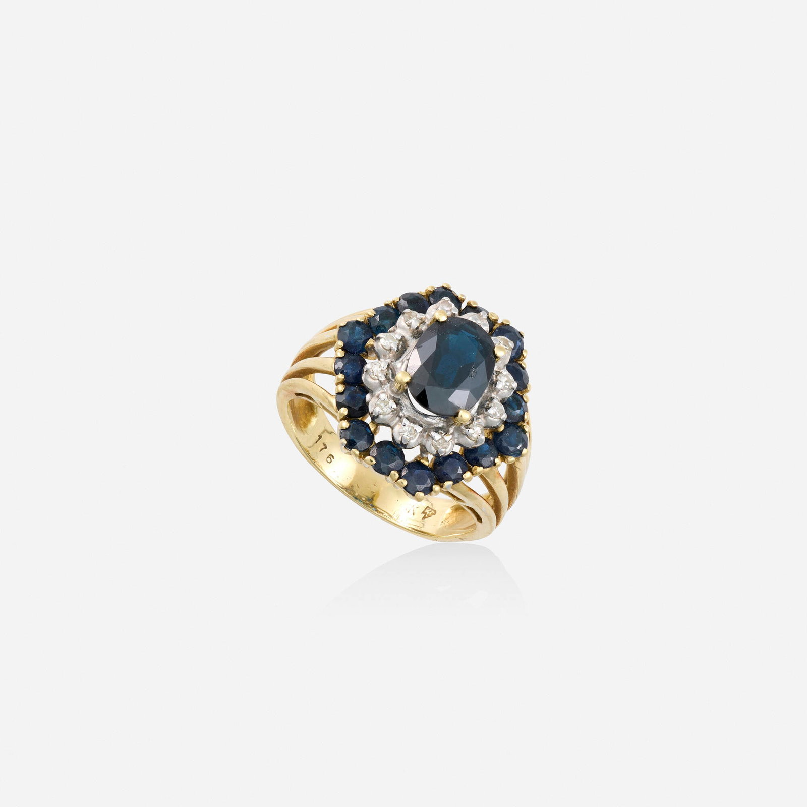 Sapphire, diamond, and gold ring: Sapphire, diamond, and gold ring Set with an oval-cut sapphire framed by single-cut diamonds and circular-cut sapphires 14k yellow and white gold Ring size 4.75-5; Gross weight 3.2 dwts This work will