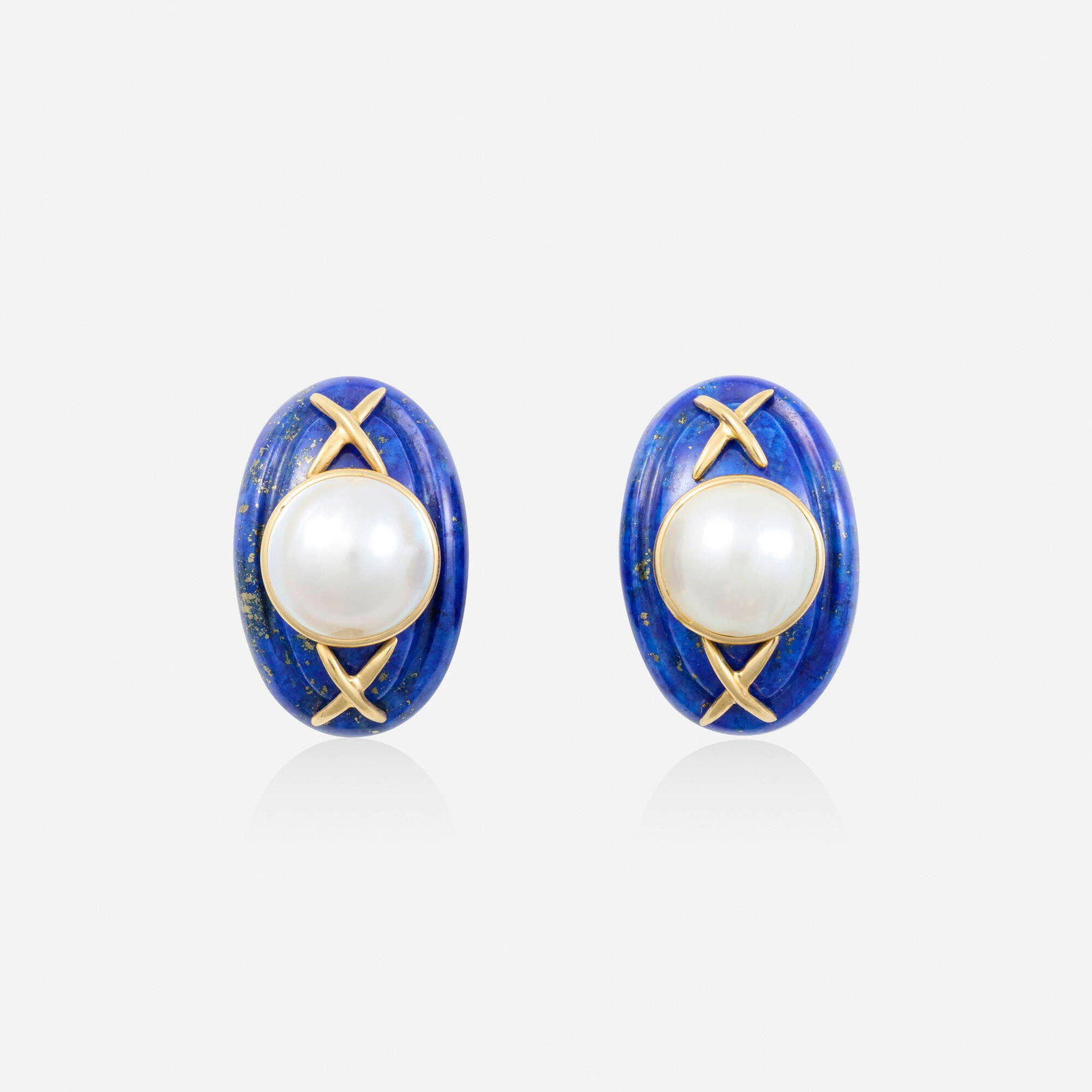 Lapis lazuli, mabe pearl, and gold earrings: Lapis lazuli, mabe pearl, and gold earrings Each set with a carved lapis lazuli and mabe pearl 14k yellow gold 1 x 0.625 in; Gross weight 10.1 dwts Provenance: Private New York City Collection