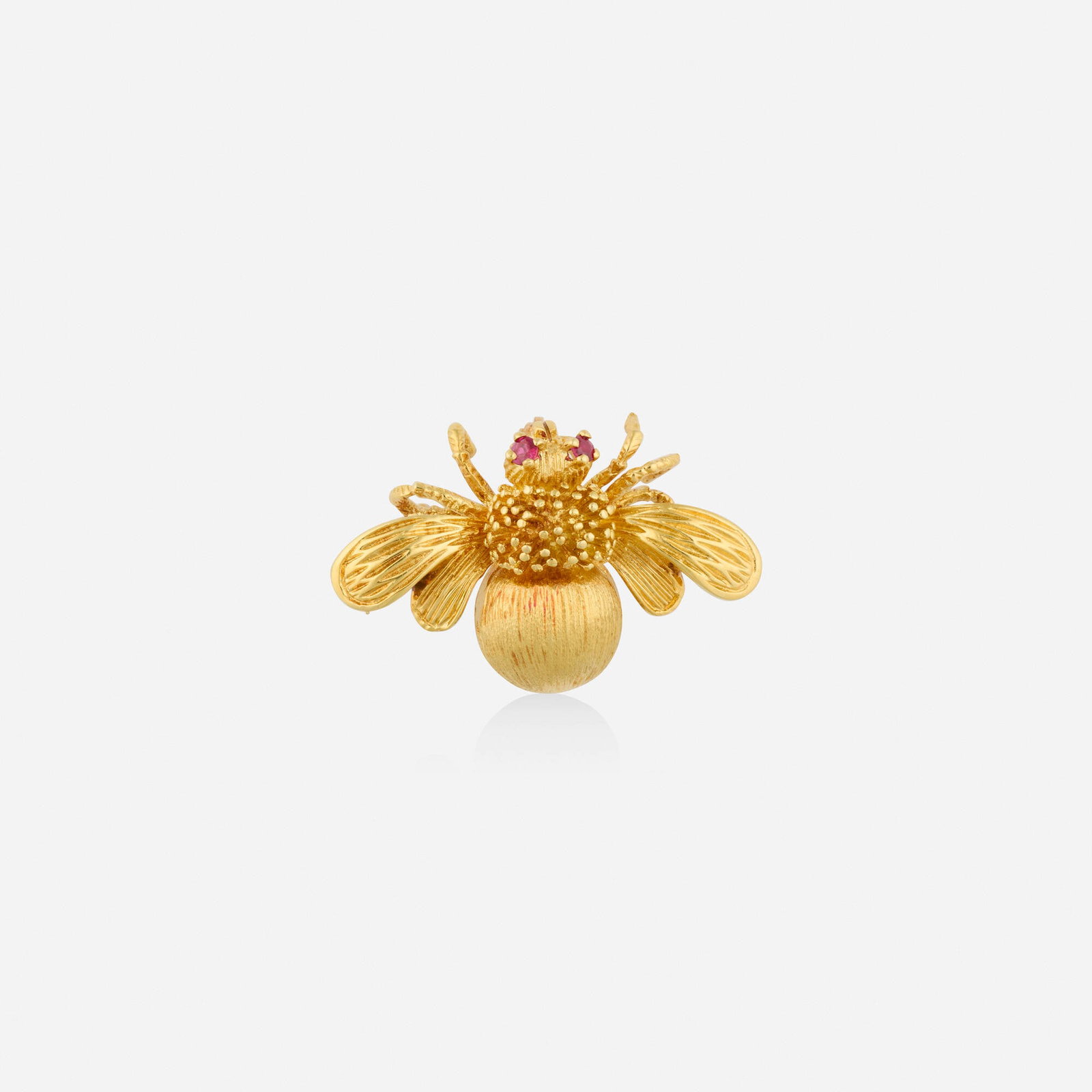 Tiffany & Co., Ruby and gold brooch: Tiffany & Co. Ruby and gold brooch The textured bee set with circular-cut ruby eyes 18k yellow gold Signed Tiffany & Co 1.375 x 0.875 in; Gross weight 7.5 dwts Sold with signed pouch and box