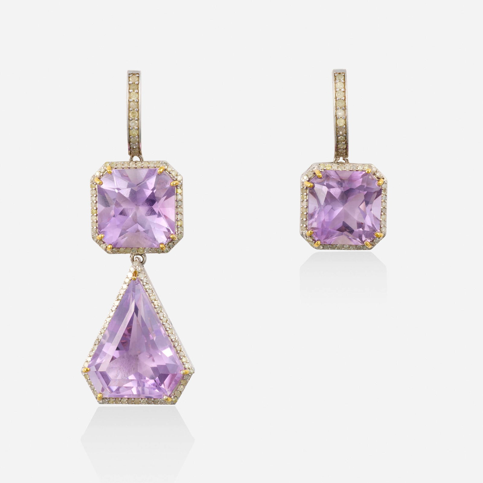 Amethyst and diamond earrings: Amethyst and diamond earrings The asymmetrical earrings, each set with an fancy-cut amethyst framed by single-cut diamonds, one further set with a kite-shaped amethyst Silver, yellow gold 2.125 x 0.62