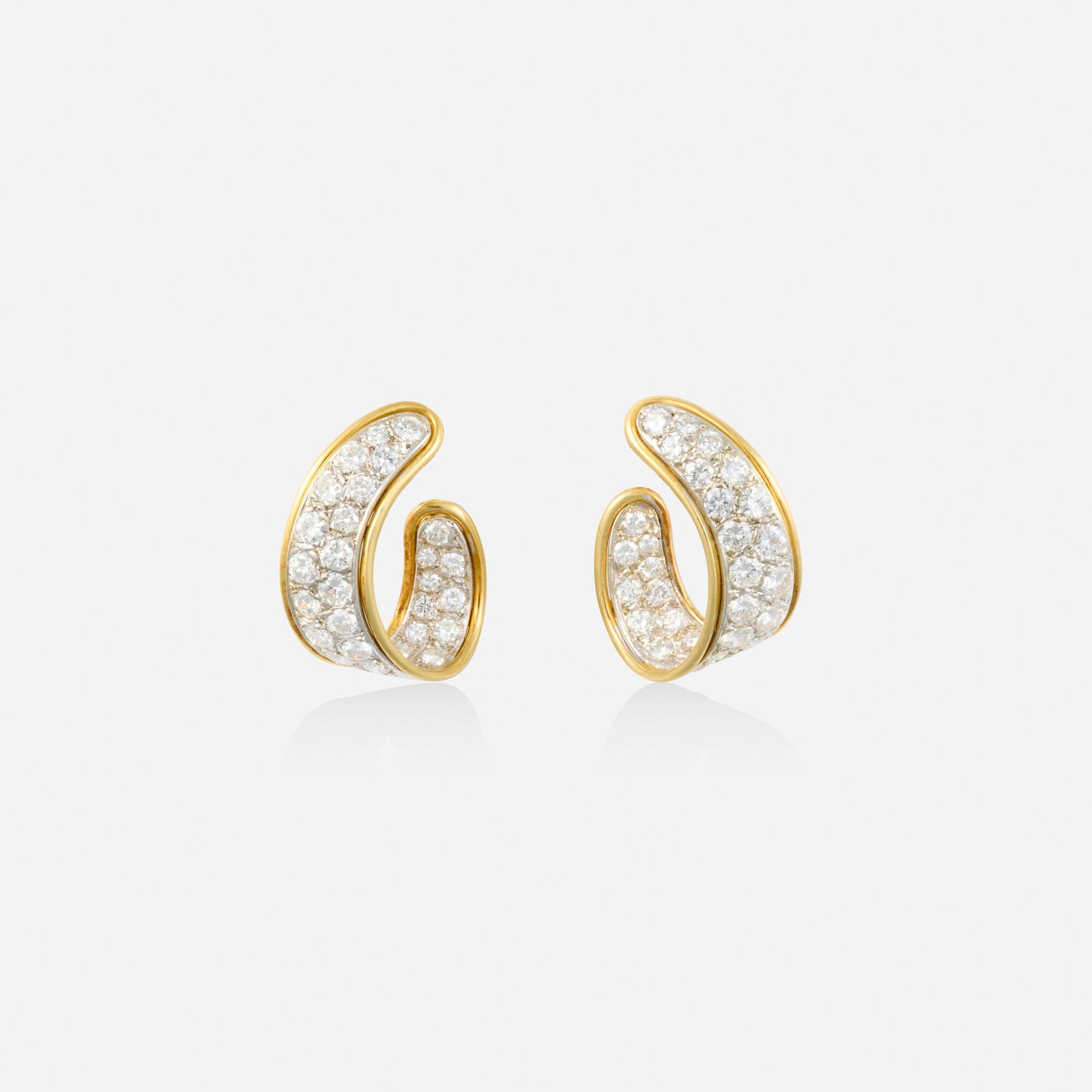 Diamond and bicolor gold earrings: Diamond and bicolor gold earrings Each set in and out with round brilliant-cut diamonds Yellow and white gold 0.625 x 0.50 in; Gross weight 3.9 dwts Provenance: Private New York City Collection
