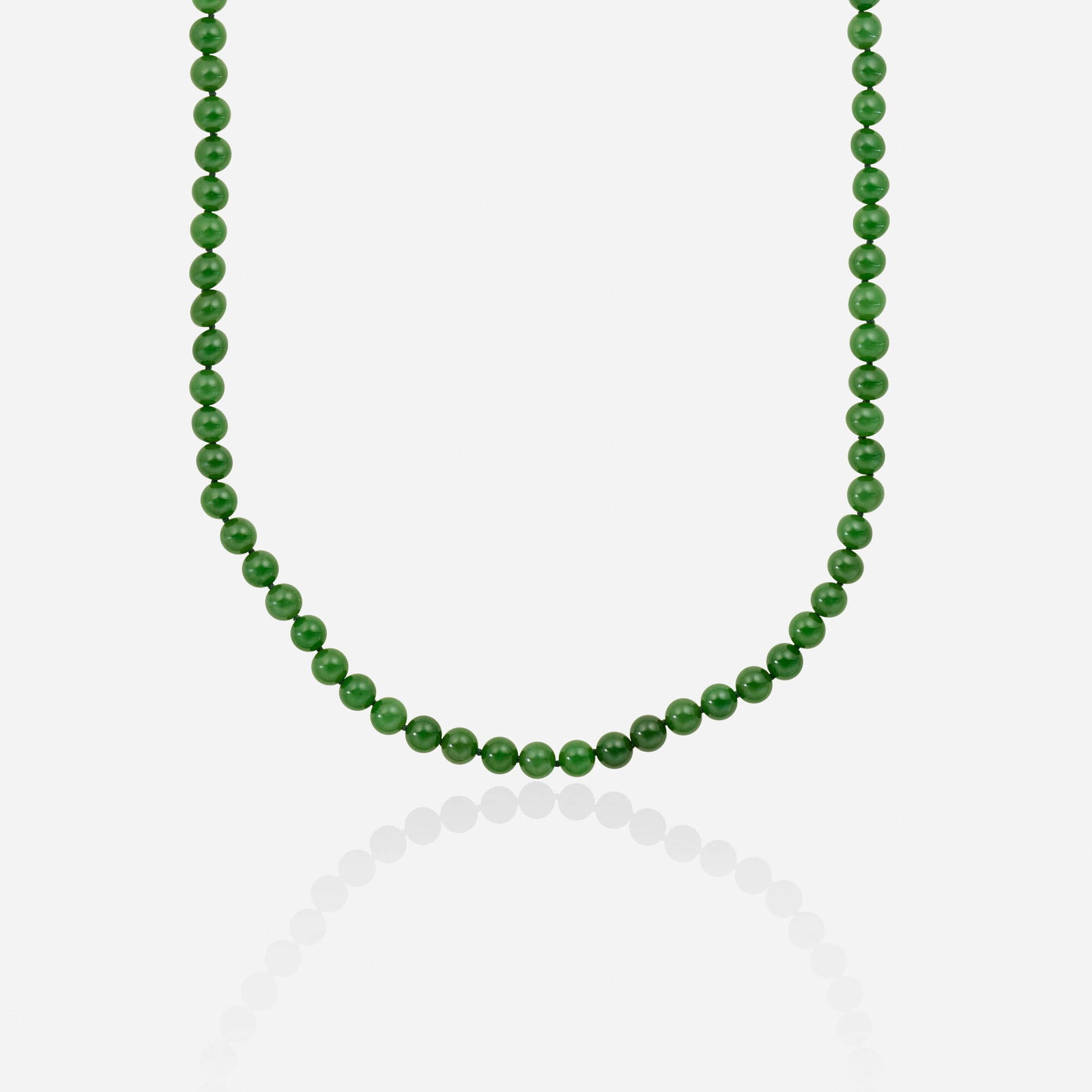 Nephrite jade and gold necklace: Nephrite jade and gold necklace Strung with nephrite jade beads 14k yellow gold 30 in; Gross weight 57.4 dwts This work will ship from Lambertville, New Jersey.