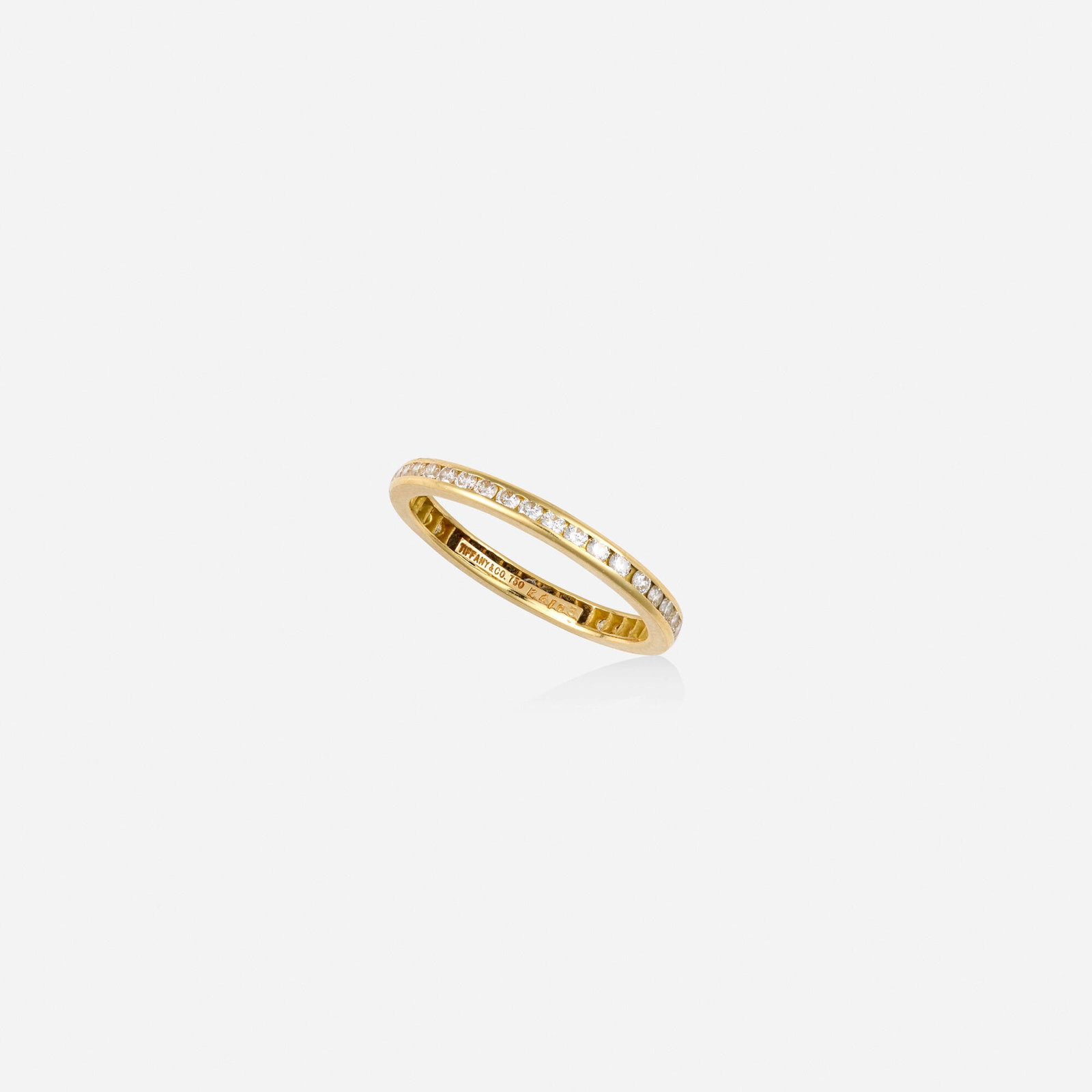 Tiffany & Co., Diamond and gold ring: Tiffany & Co. Diamond and gold ring Channel-set with round brilliant-cut diamonds 18k yellow gold Signed Tiffany & Co. Ring size 6; Gross weight 1.0 dwts This work will ship f