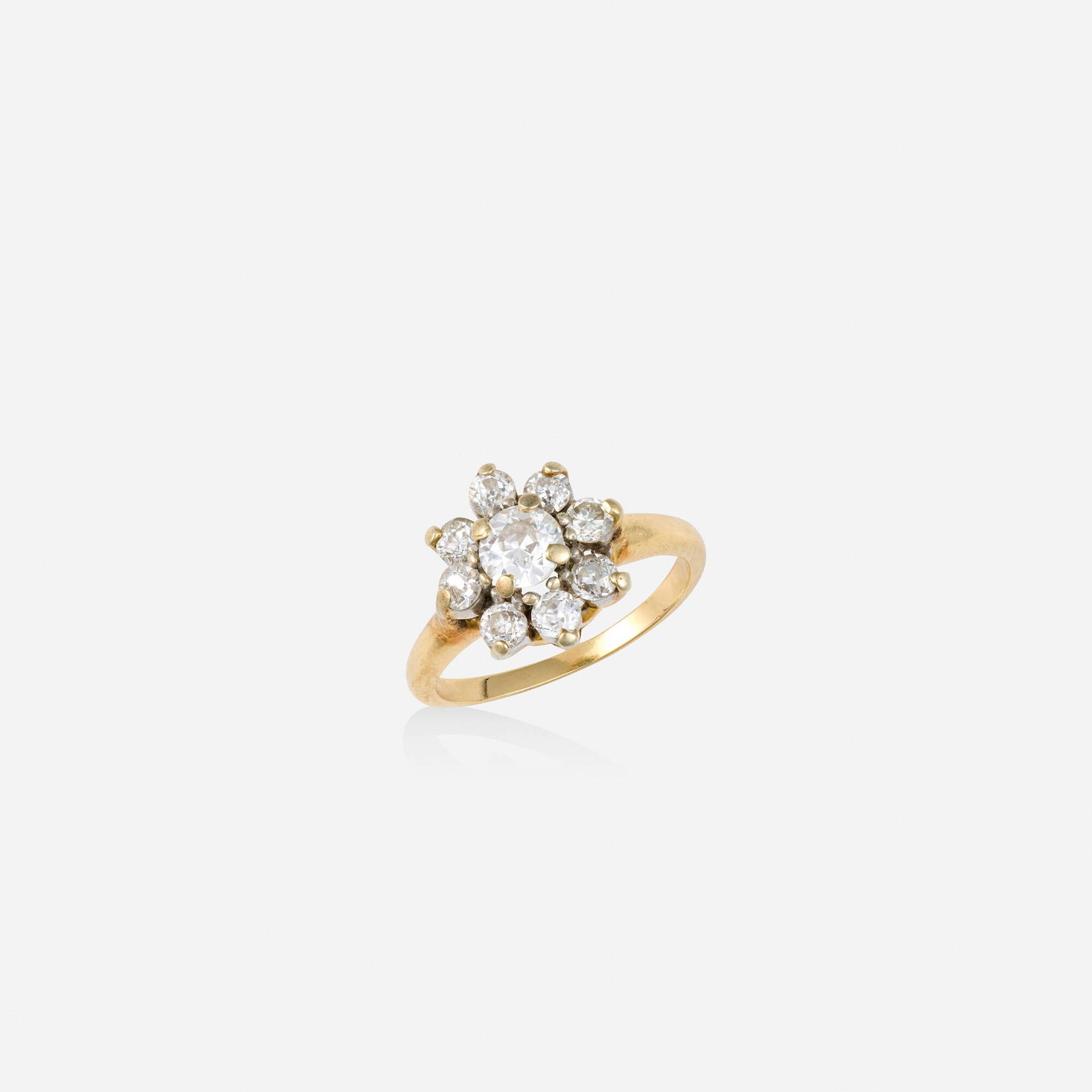 Diamond and gold ring: Diamond and gold ring Set with a cluster of old European and old mine-cut diamonds Yellow and white gold Ring size 5; Gross weight 1.9 dwts This work will ship from Lambertville, New Jersey.