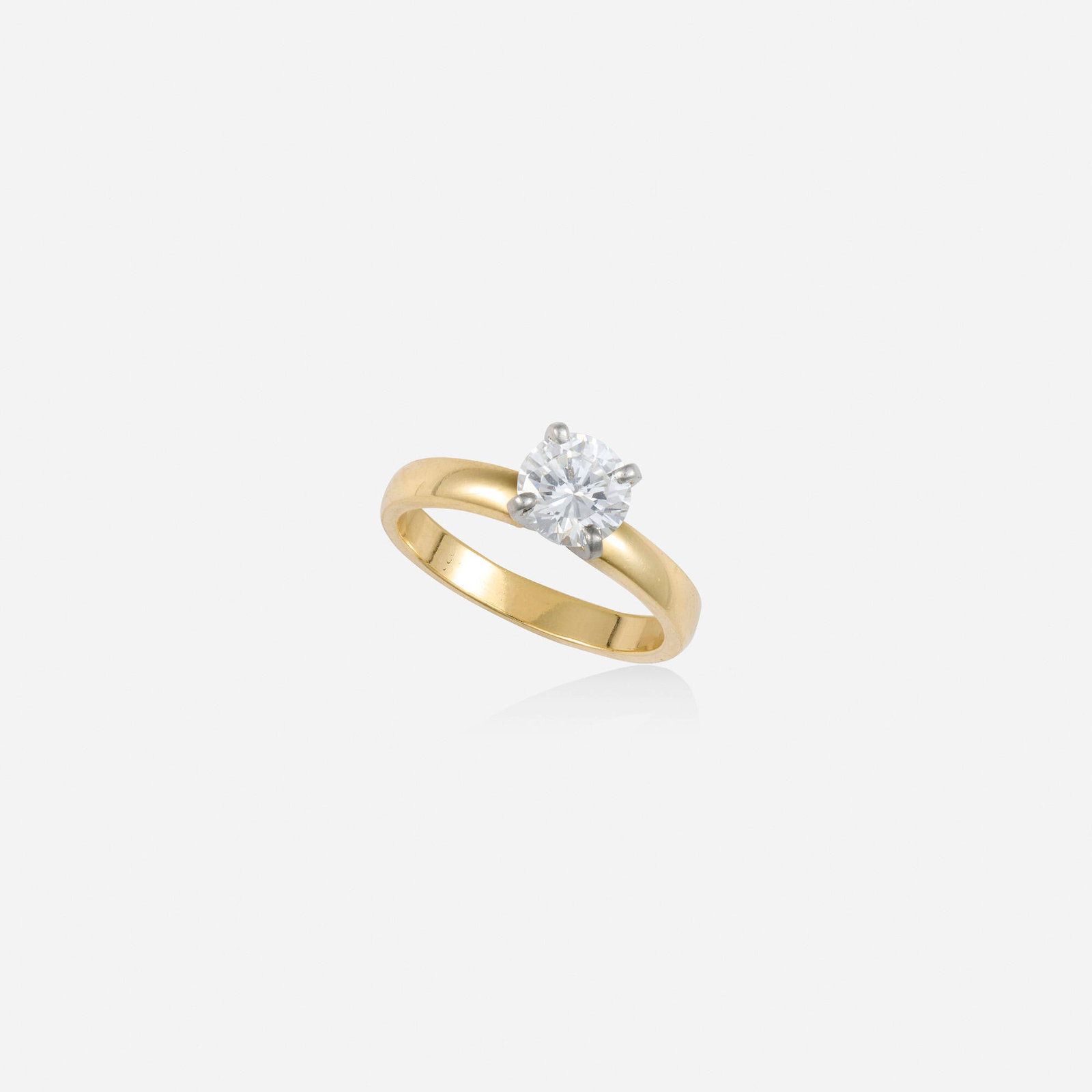 Diamond, gold, and platinum engagement ring: Diamond, gold, and platinum engagement ring Set with a round brilliant-cut diamond 14k yellow gold, platinum Ring size 6; Gross weight 2.3 dwts This work will ship from Lambertville, New Jersey.