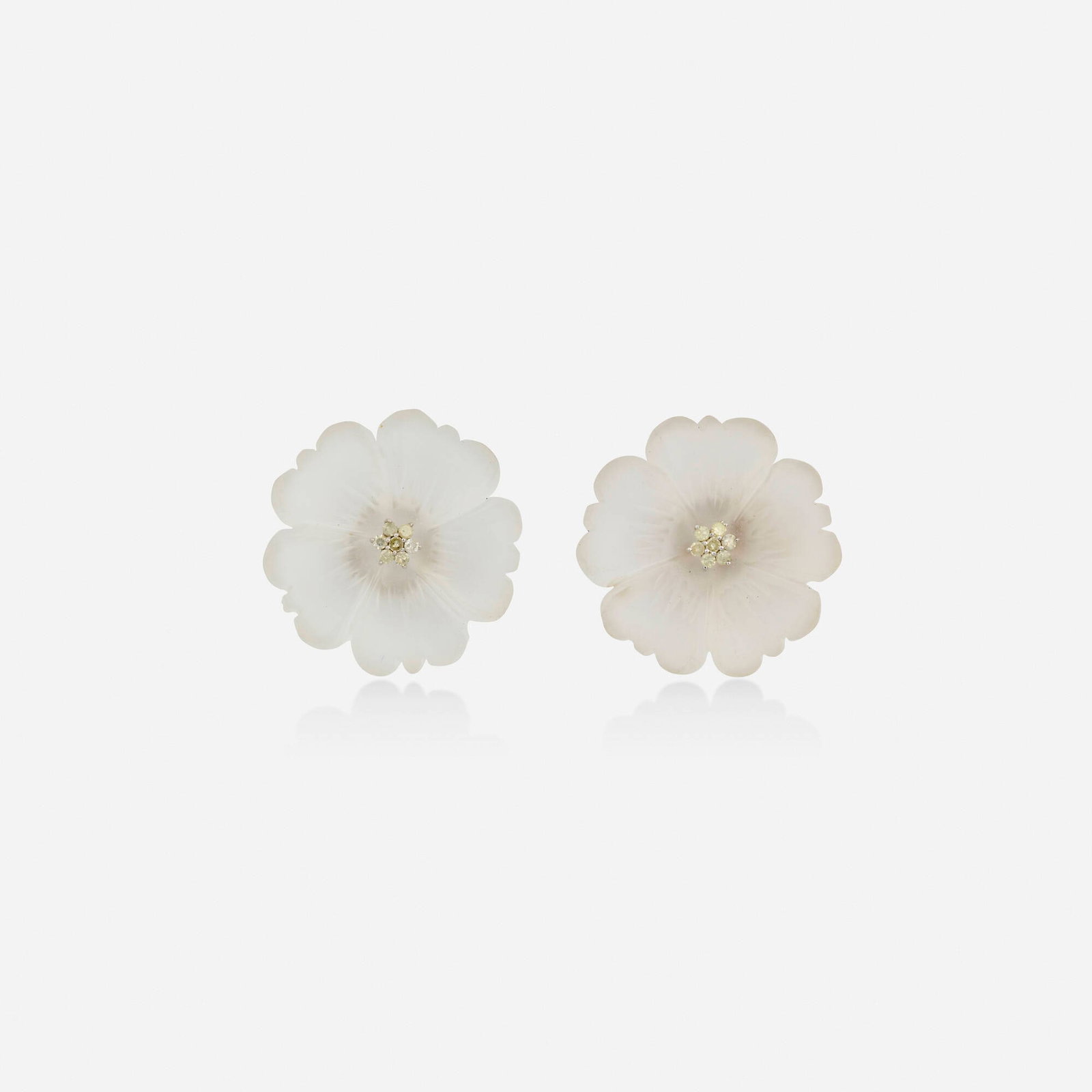 Rock crystal and diamond earrings: Rock crystal and diamond earrings Each a carved rock crystal flower with single-cut diamond center Silver and yellow gold 1 in; Gross weight 7.4 dwts This work will ship from Lambertville, New Jersey.