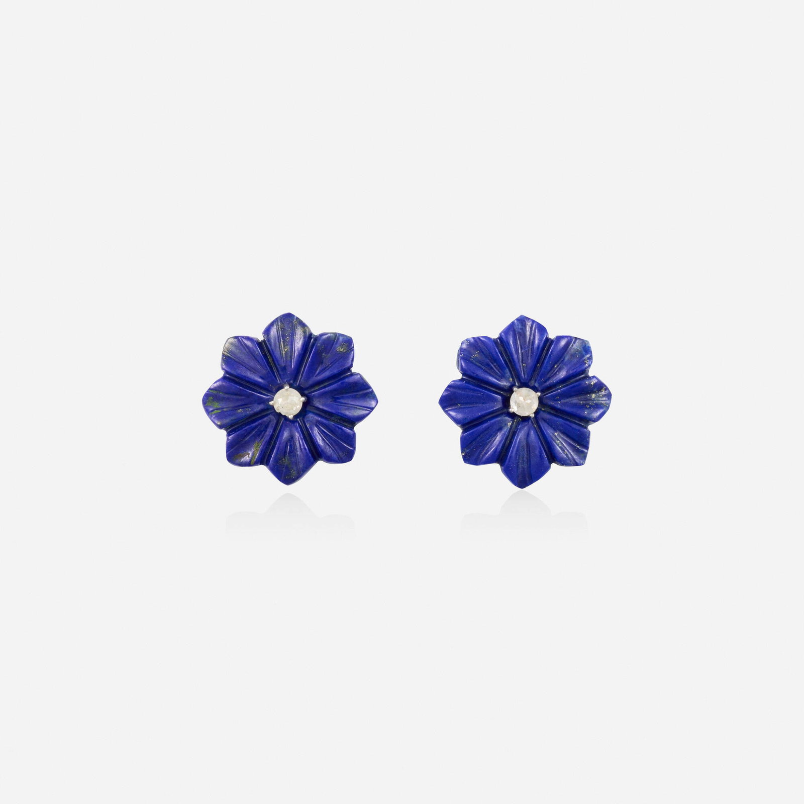 Lapis lazuli and diamond earrings: Lapis lazuli and diamond earrings Each a carved lapis lazuli flower, set with a rose-cut diamond Silver, yellow gold 0.625 in; Gross weight 2.8 dwts This work will ship from Lambertville, New Jersey.