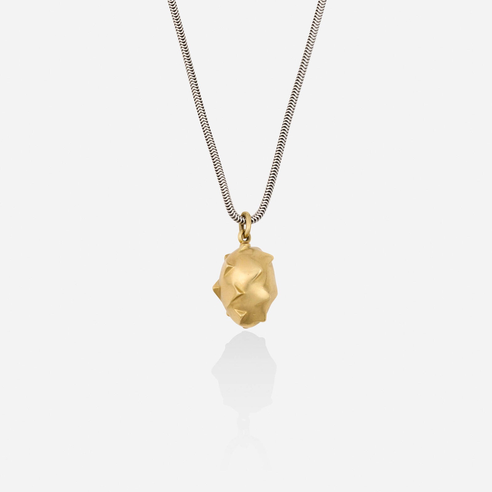 Pedro Boregaard, Gold and silver necklace: Pedro Boregaard Gold and silver necklace The sculptural egg pendant suspended from the long silver snake chain; 1988 18k yellow gold Signed with maker's mark for Pedro Boregaard to pendant bail