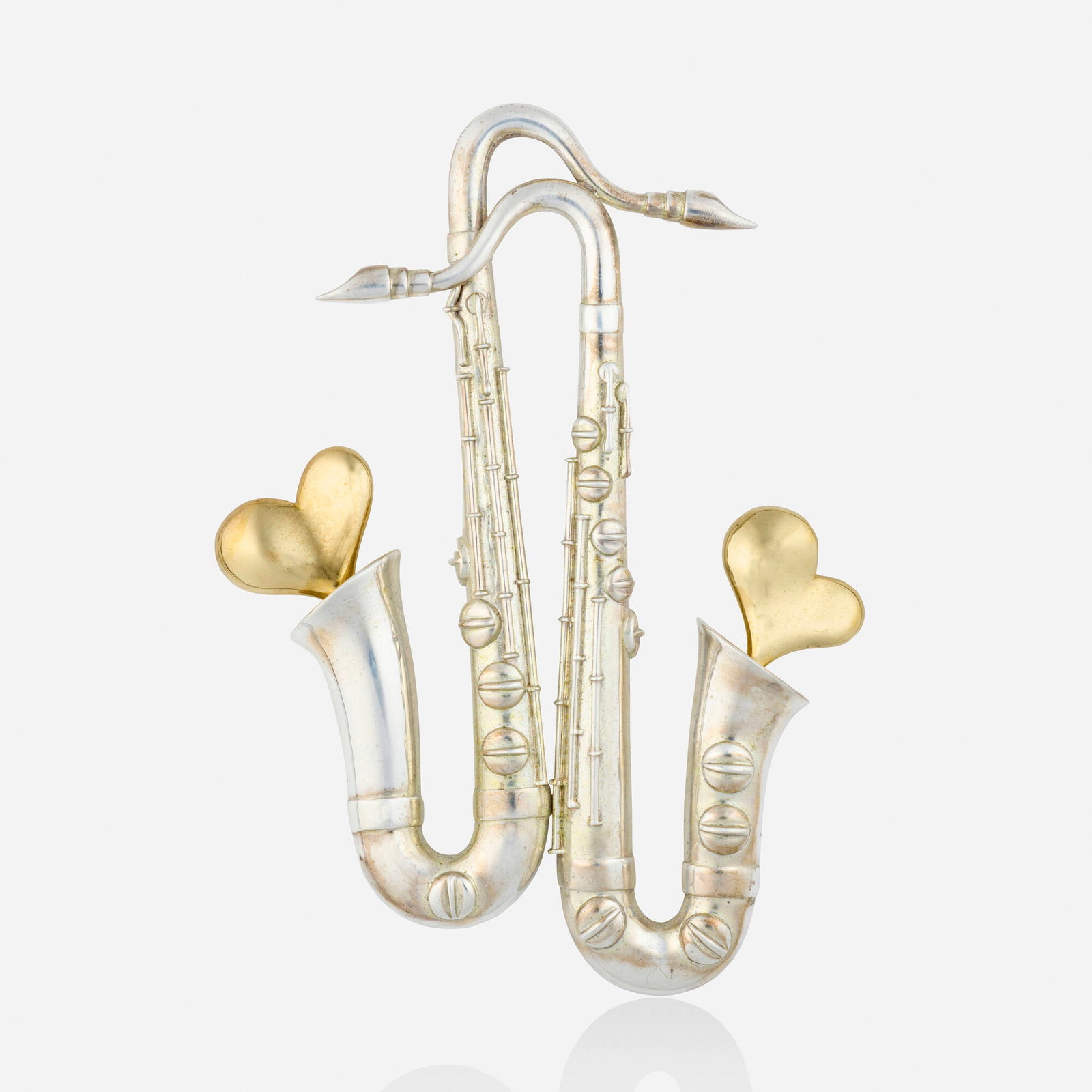 Arman and Movado, Sterling silver and gold brooch: Arman and Movado Sterling silver and gold brooch Designed as two saxophones and hearts Sterling silver, 18k yellow gold Signed Arman and Movado 5 x 3.625 in; Gross weight 50.1 dwts