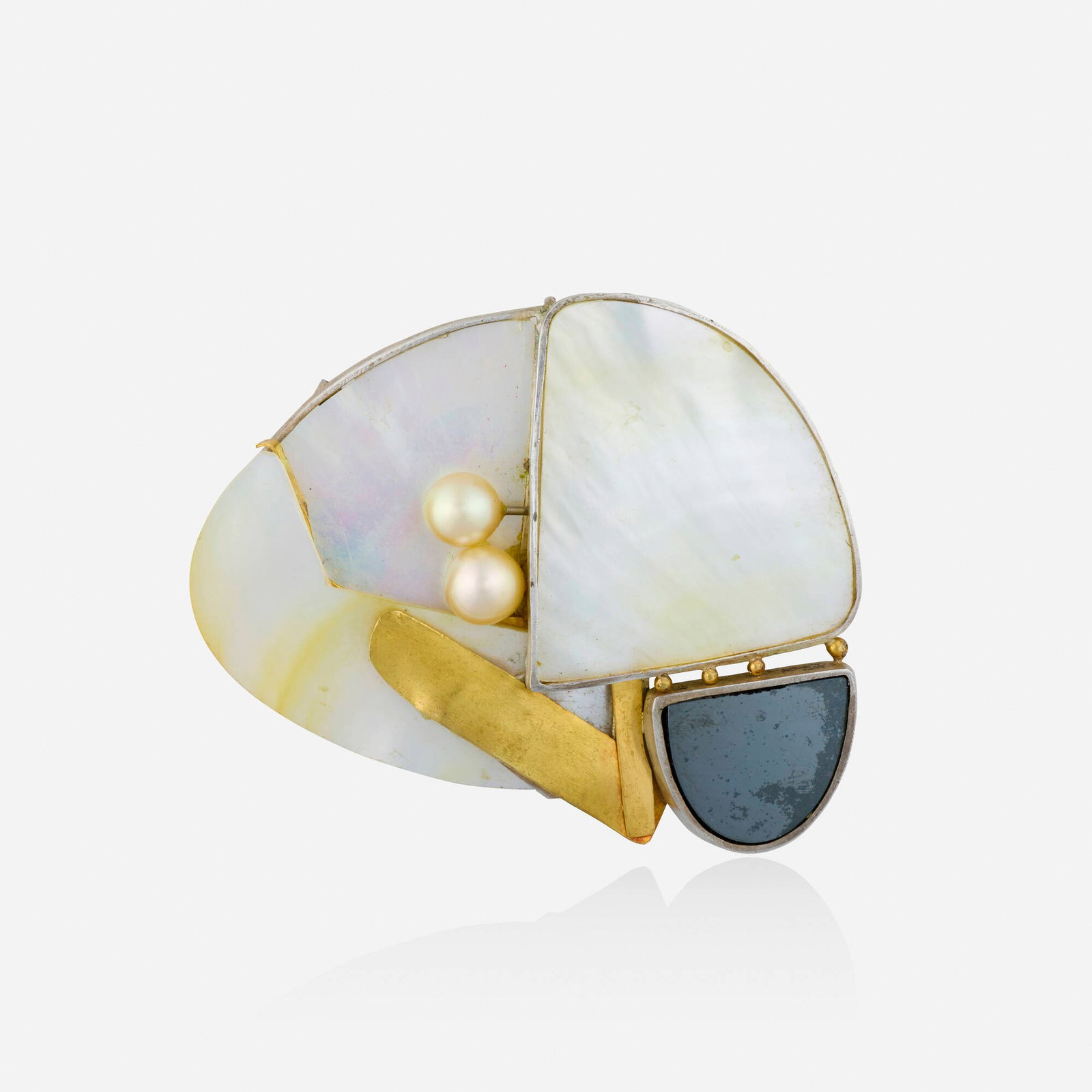 Takashi Wada, Multi-gem, silver, and gold pendant brooch: Takashi Wada Multi-gem, silver, and gold pendant brooch Set with cultured pearls, mother-of-pearl, and hematite; 1985 Silver, yellow gold Signed Takashi Wada 2.625 x 2.25 in; Gross weight 20.5 dwt