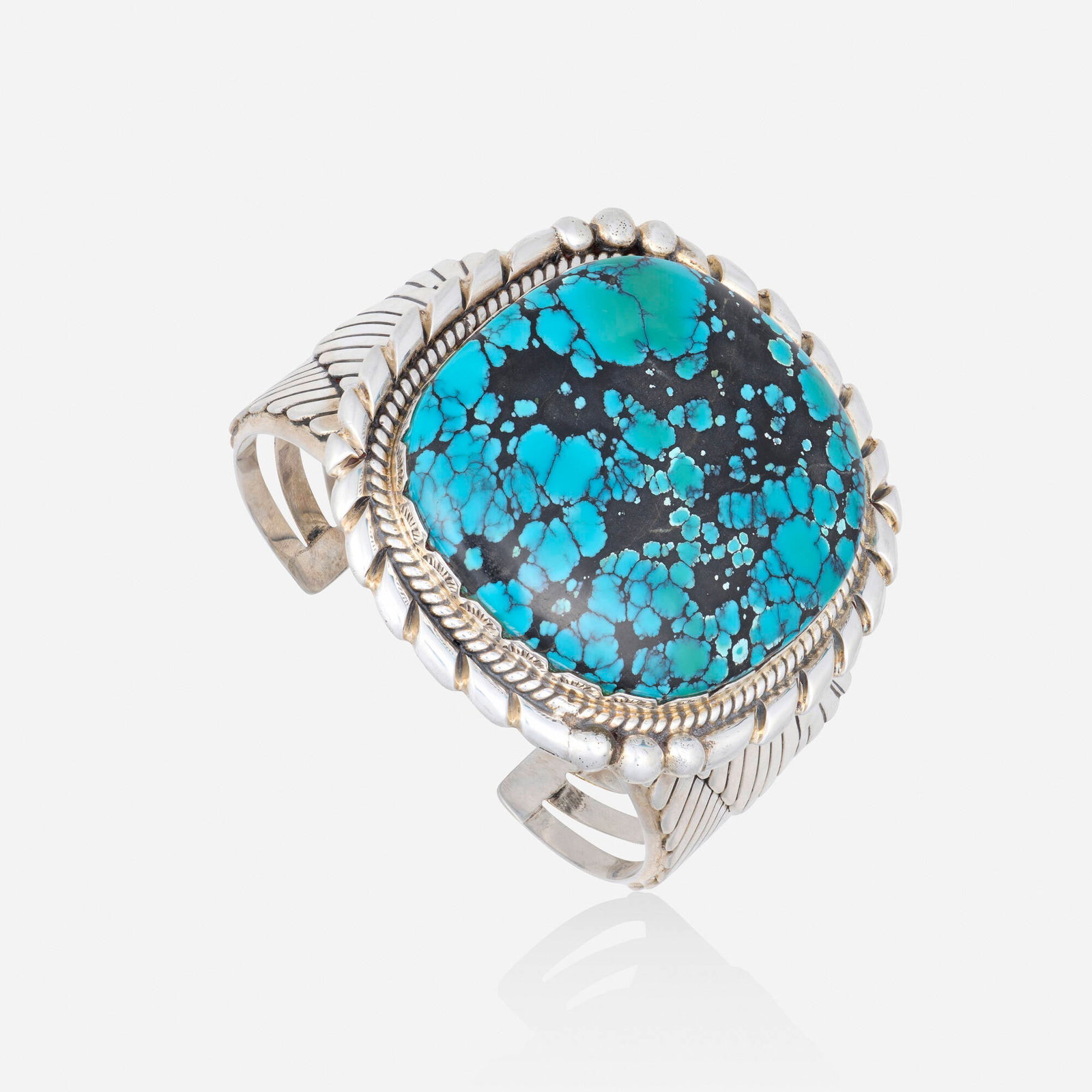 Ronnie & Ramil Glodove, Turquoise and sterling silver bracelet: Ronnie & Ramil Glodove Turquoise and sterling silver bracelet The cuff set with a large polish turquoise Signed with maker's mark for Ronnie & Ramil Glodove Inner circ. 7.75 in, width 2.875 in;