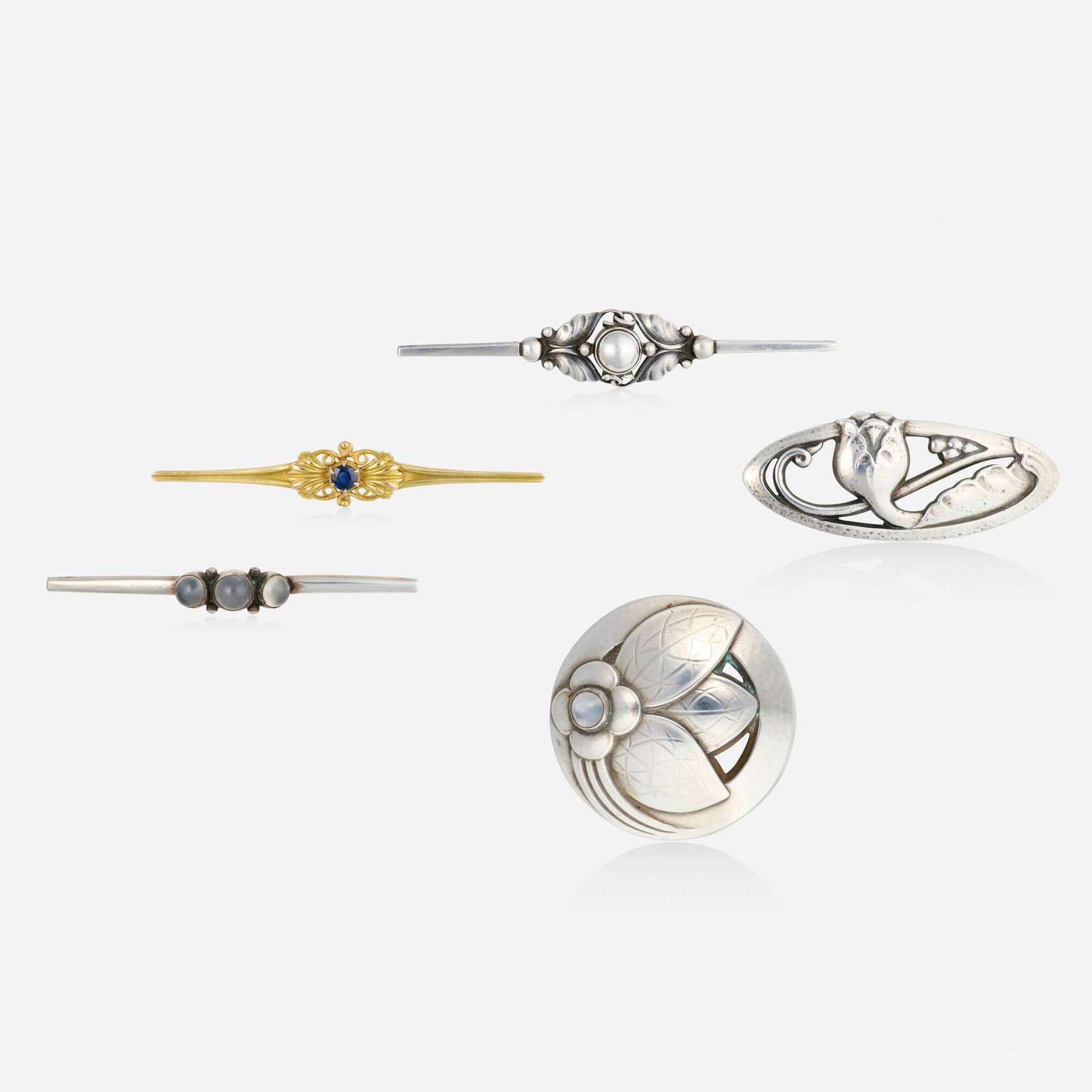 Georg Jensen, Group of sterling silver and gold brooches: Georg Jensen Group of sterling silver and gold brooches Comprising a scrolling gold brooch set with a circular-cut sapphire, no. 189, 1933-1944; a bar brooch set with cat's eye moonstone, no. 3, 