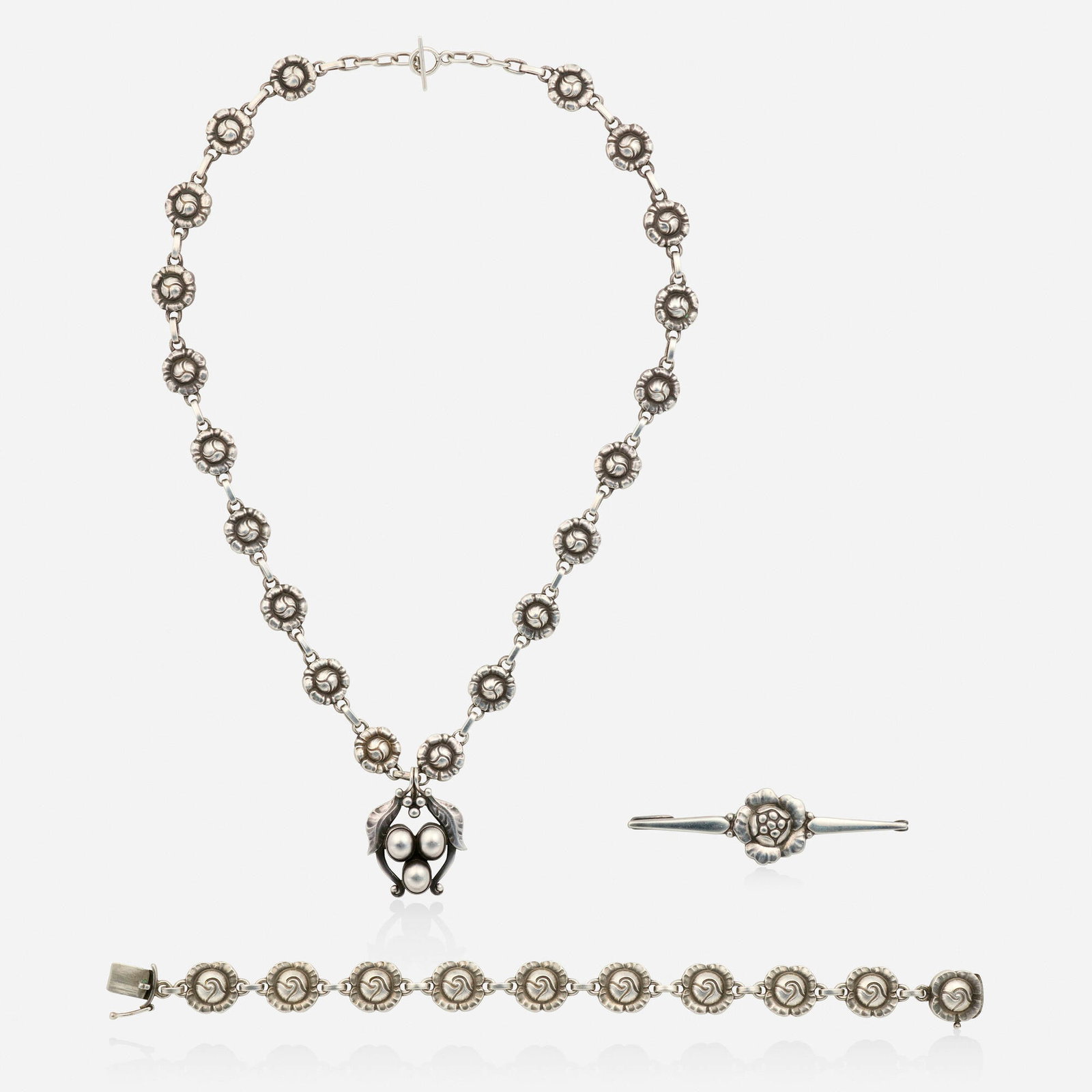 Georg Jensen, Group of silver jewlery: Georg Jensen Group of silver jewlery Each of floral design, comprising a brooch, no. 143, 1910-1925; a bracelet, no. 44, after 1945; a necklace, no. 48, 1910-1925; and a detachable pendant, no. 11, 19