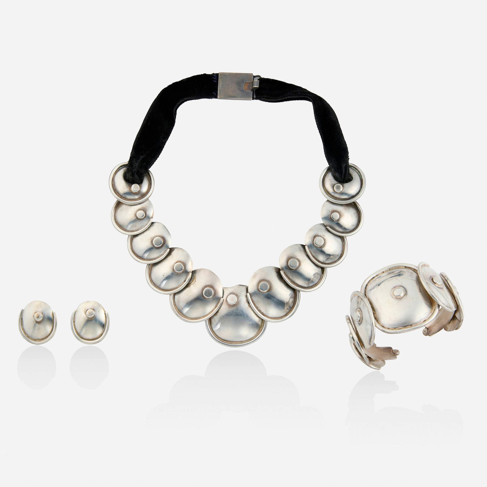 Hector Aguilar, attribution, Silver necklace, bracelet, and earrings: Hector Aguilar, attribution Silver necklace, bracelet, and earrings The necklace of graduated discs joined by velvet ribbon, the cuff bracelet and earrings similar Silver Necklace 15.50 in, bracelet i