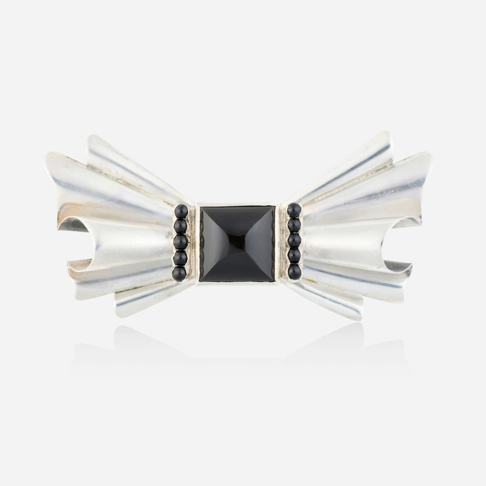 Frederick Davis, Black onyx and silver brooch: Frederick Davis Black onyx and silver brooch Designed as a bow, set with carved and cabochon black onyx Silver Signed with maker's mark for Frederick Davis 3.50 x 1.625 in; Gross weight 23.2