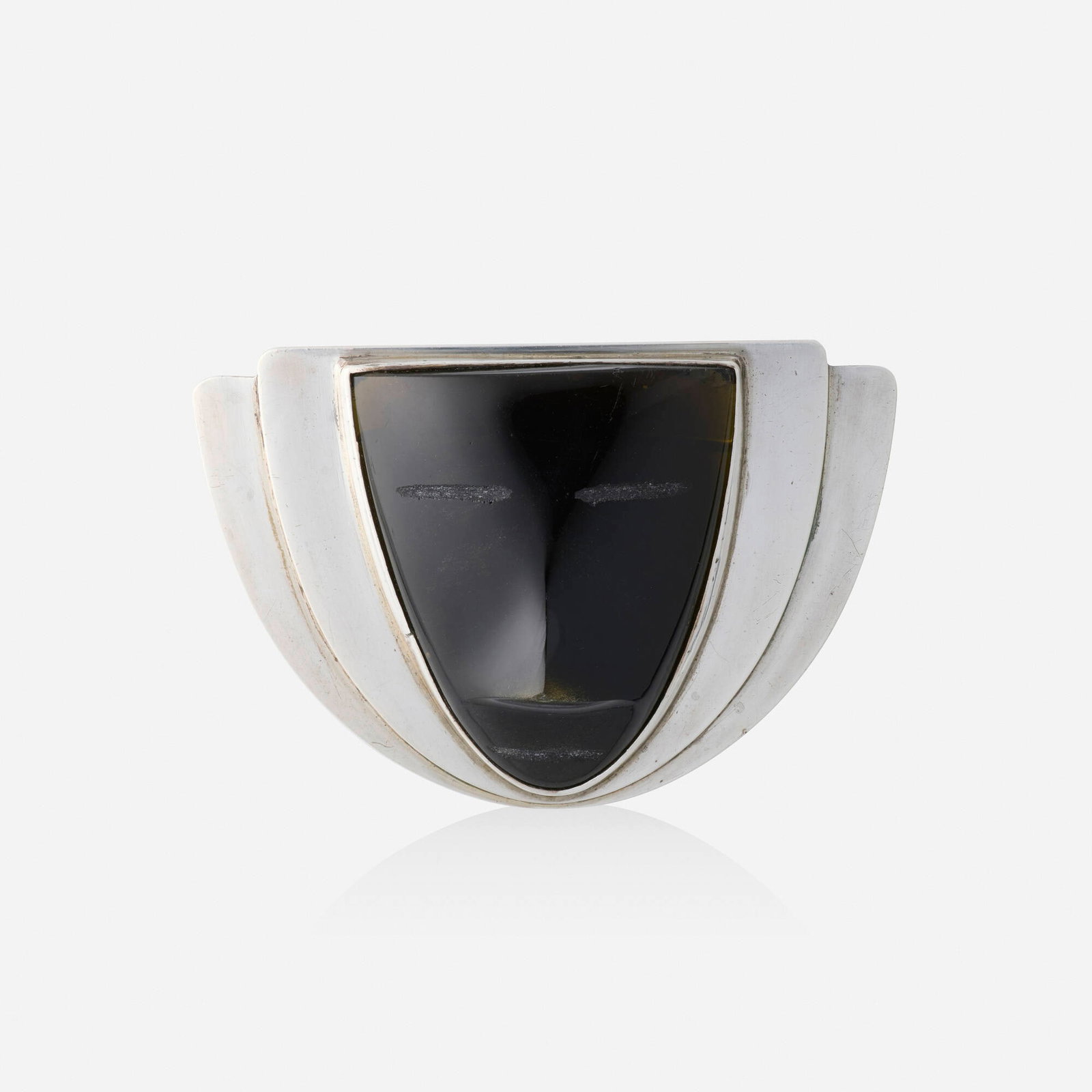 Frederick Davis, Obsidian and silver brooch: Frederick Davis Obsidian and silver brooch Set with a carved obsidian mask Silver Signed with maker's mark for Frederick Davis 2.75 x 1.875 in; Gross weight 25.1 dwts This