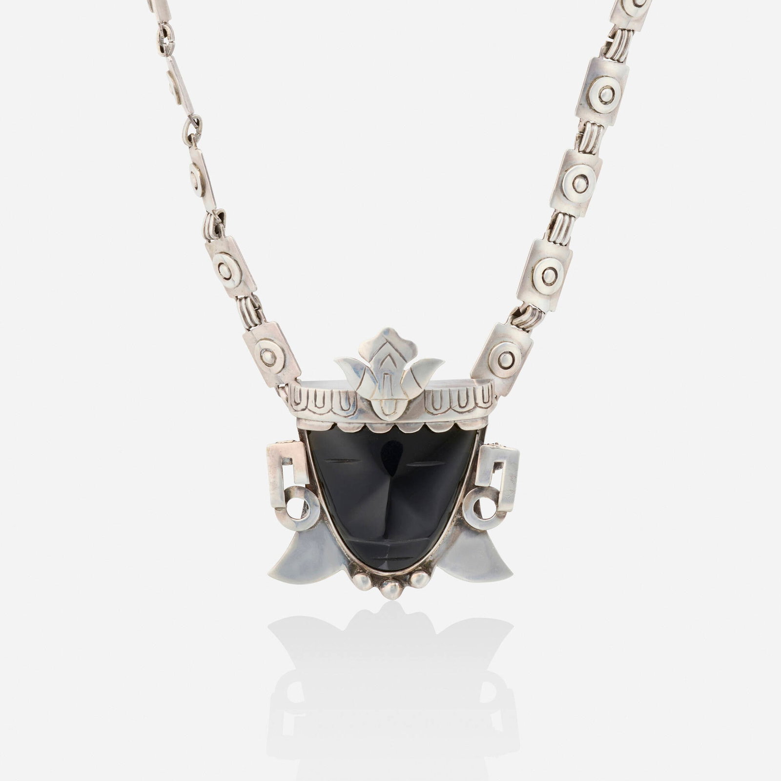 Frederick Davis, attribution, Obsidian and silver pendant brooch necklace: Frederick Davis, attribution Obsidian and silver pendant brooch necklace The pendant brooch designed with a carved obsidian mask; joined by two geometric link chains by an unidentified Mexican silvers