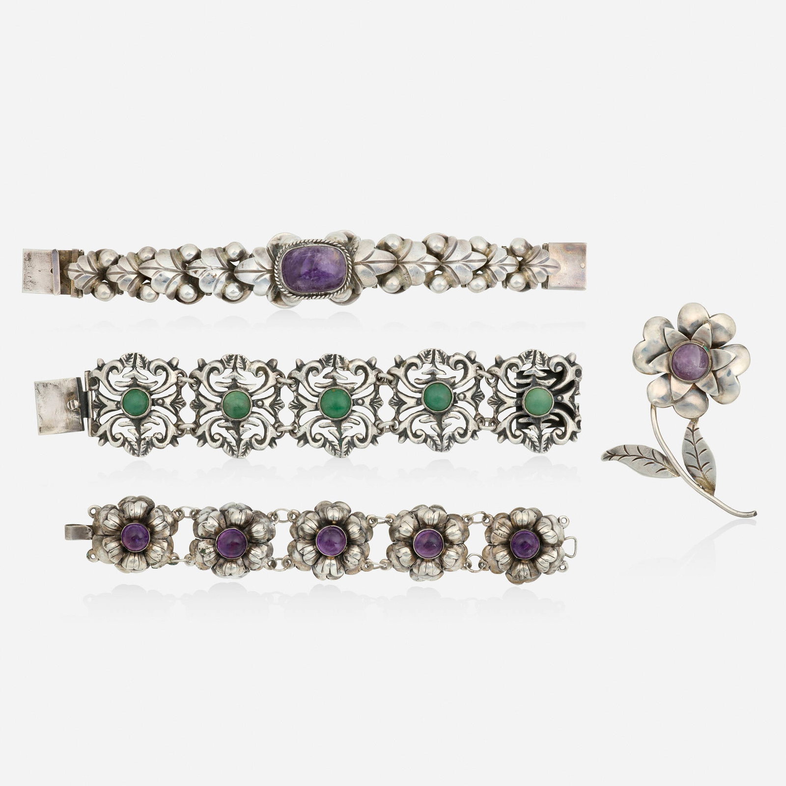 Mexican, Group of multi-gem and silver jewelry: Mexican Group of multi-gem and silver jewelry Comprising three bracelets and a brooch each of floral design, set with either cabochon amethyst or green hardstone Silver Bracelets 7 x 1.50 in, 7.25 x 1