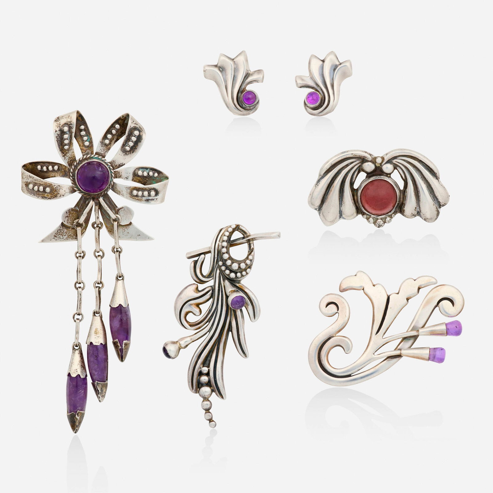 Mexican, Group of amethyst, glass, and silver jewelry: Mexican Group of amethyst, glass, and silver jewelry Comprising three brooches and a pair of earrings set with cabochon amethyst, and a brooch set with cabochon pink glass; one brooch is by Margot Van