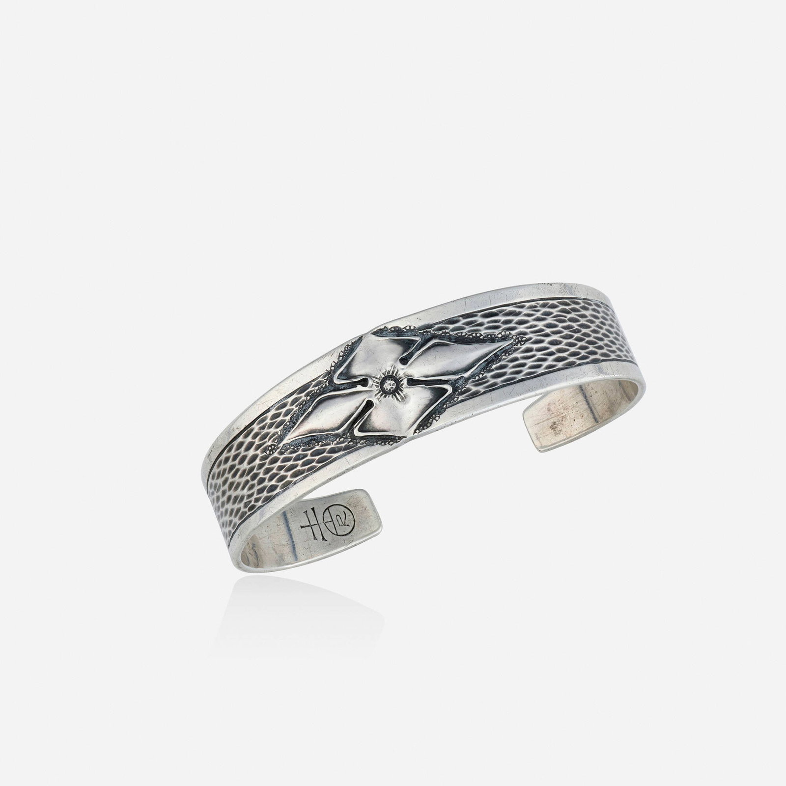 Roycroft, Sterling silver bracelet: Roycroft Sterling silver bracelet The cuff of hammered pattern, designed by Walter Jennings; 1915 Sterling silver Signed Roycroft Inner circ. 6 in, width 0.50 in; Gross weight 13.4 dwts