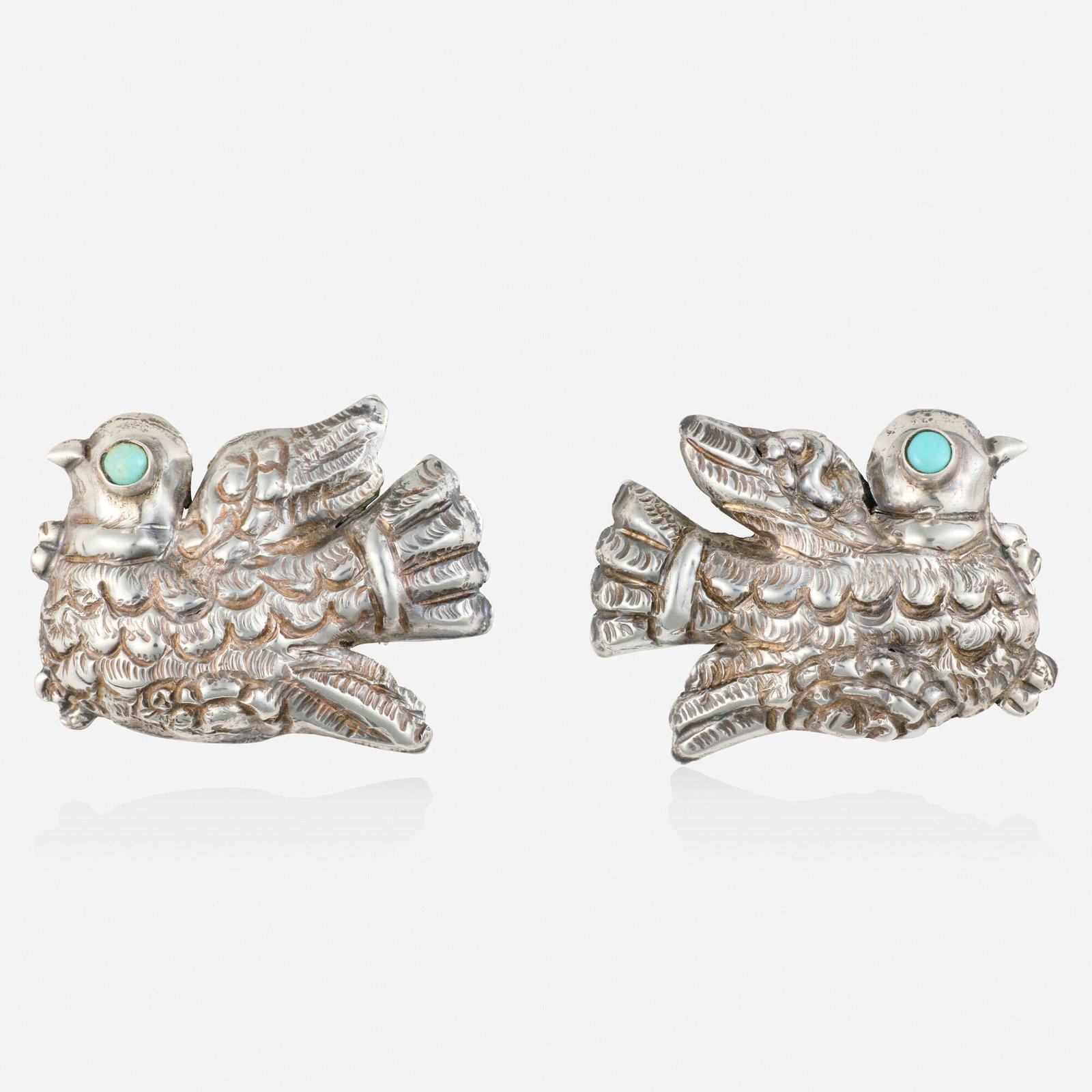 Matilde Poulat, Turquoise and sterling silver earrings: Matilde Poulat Turquoise and sterling silver earrings Each a repousse bird with cabochon turquoise eye Sterling silver Signed Matl 1.625 x 1.25 in; Gross weight 11.0 dwts This