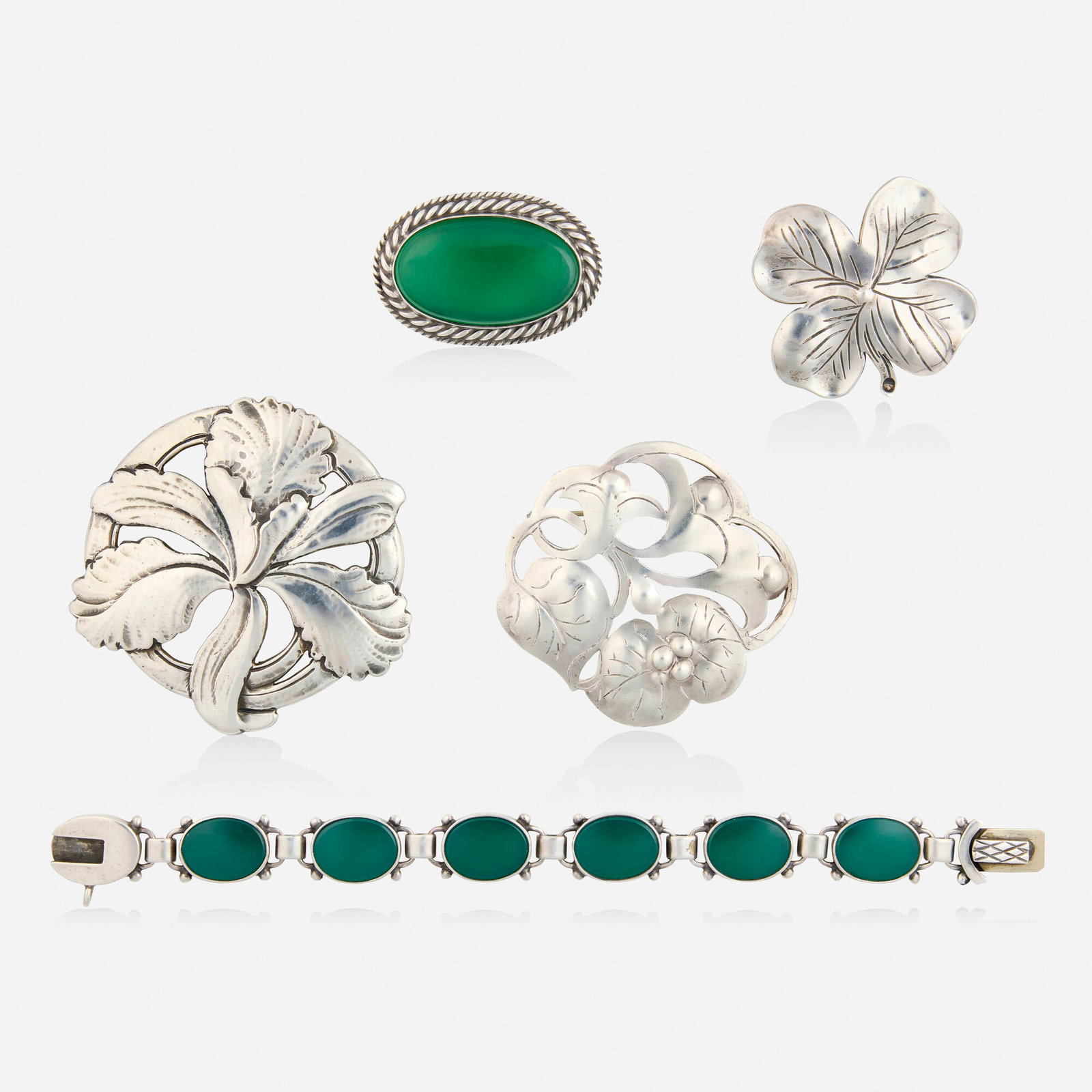 The Kalo Shop, Group of sterling silver jewelry: The Kalo Shop Group of sterling silver jewelry Comprising a bracelet and brooch each set with dyed green chalcedony, a floral brooch, a four-leaf clover brooch, no. 246, and a floral brooch, no. 52 St