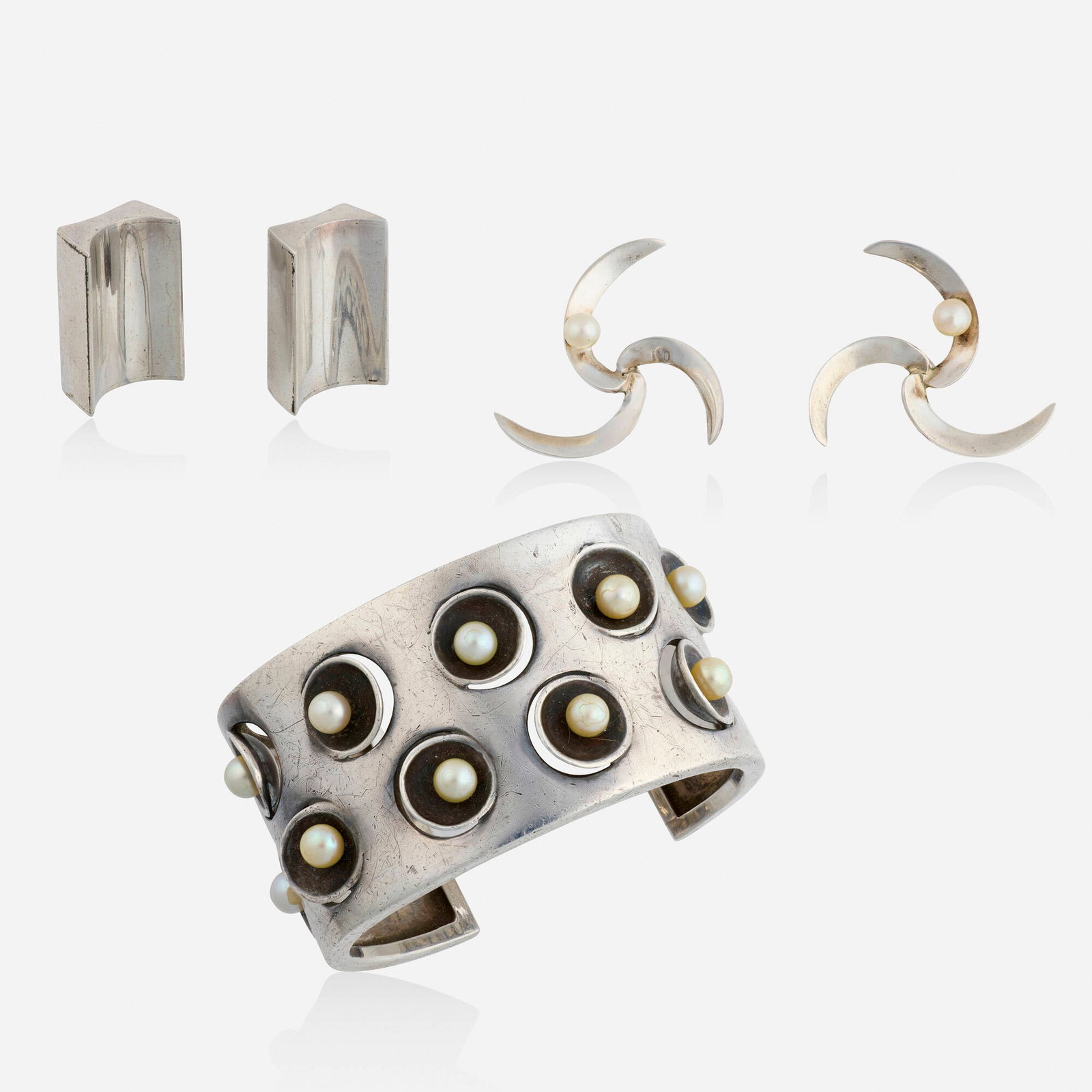 Antonio Pineda, Group of sterling silver jewelry: Antonio Pineda Group of sterling silver jewelry Comprising a cuff bracelet and pair of earrings each set with cultured pearls, and a pair of rectangular concave earrings Sterling silver Signed with ma