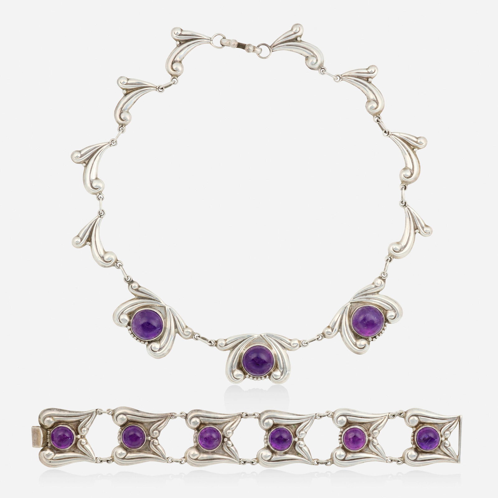 Mexican, Amethyst and sterling silver necklace and bracelet: Mexican Amethyst and sterling silver necklace and bracelet Each of scrolling design, set with cabochon amethysts Sterling silver Necklace 15.75 in, bracelet 7.25 x 1 in; Gross weight 43.4 dwts