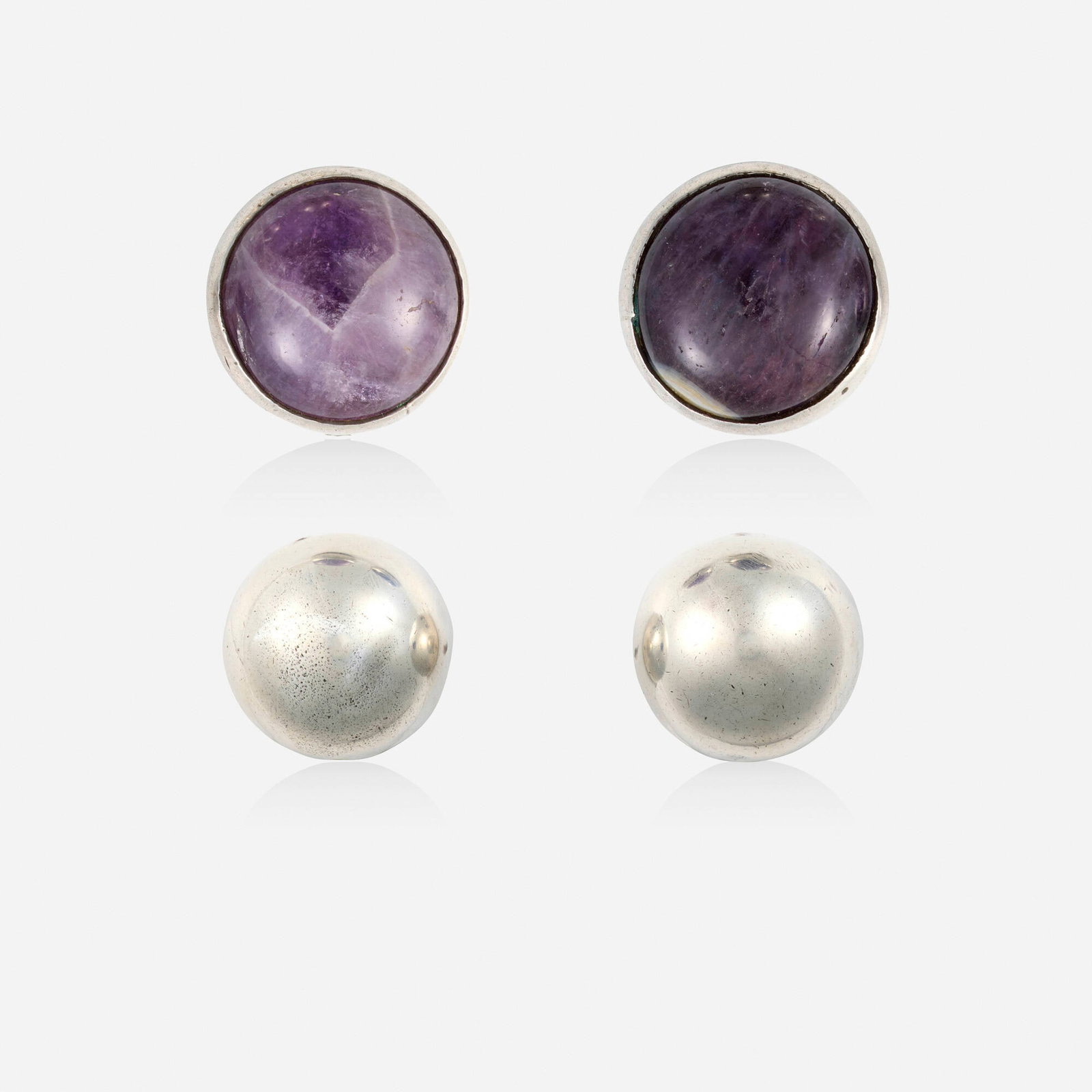 William Spratling, Two pairs of silver earrings: William Spratling Two pairs of silver earrings Comprising two pairs of domed earrings, one pair set with cabochon amethysts; 1934-1945 Silver Signed with maker's marks for William Spratling to e