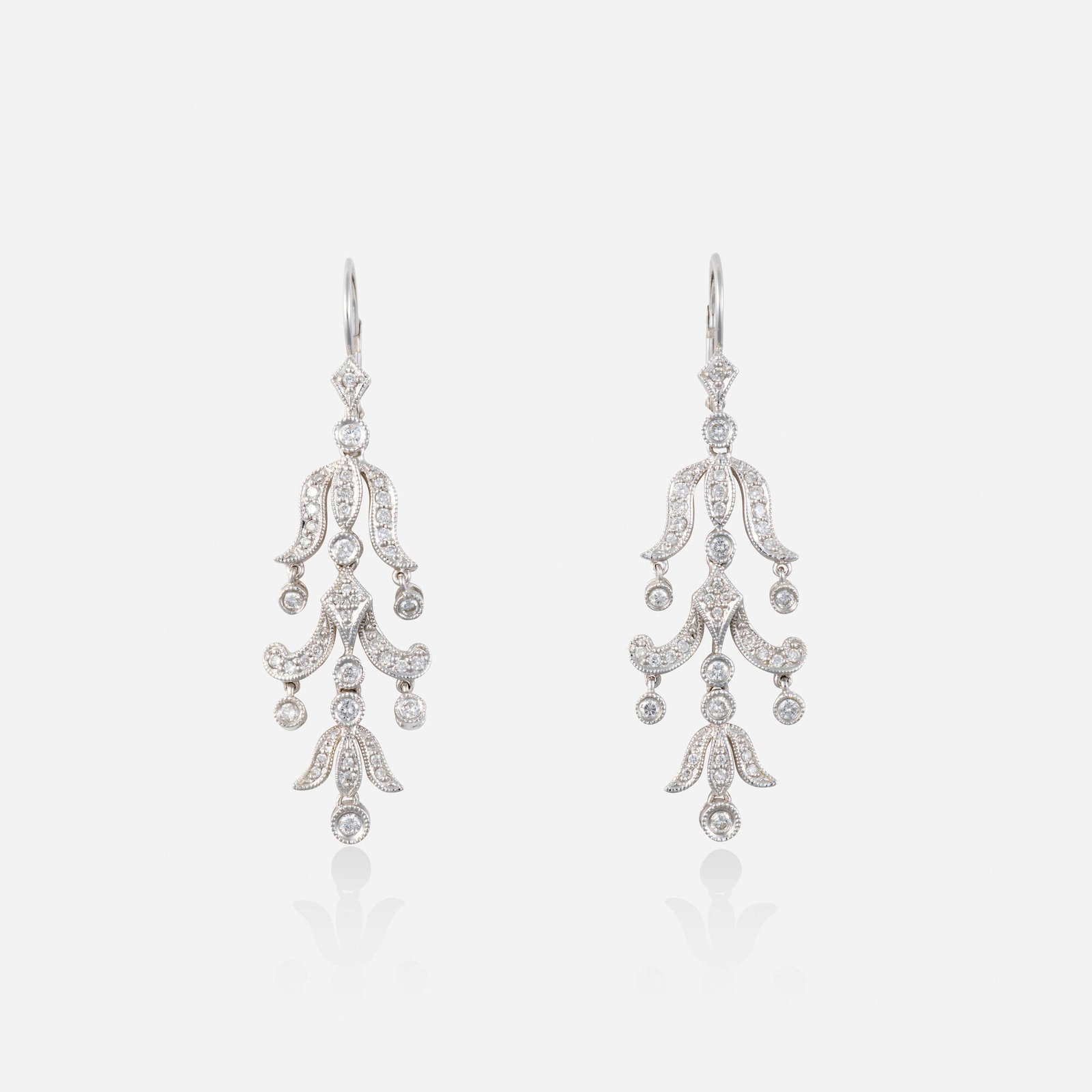 Diamond and white gold earrings: Diamond and white gold earrings Each of chandelier design, set with round brilliant-cut diamonds 14k white gold 1.75 x 0.50 in; Gross weight 3.3 dwts This work will ship from Lambertville, New Jersey.