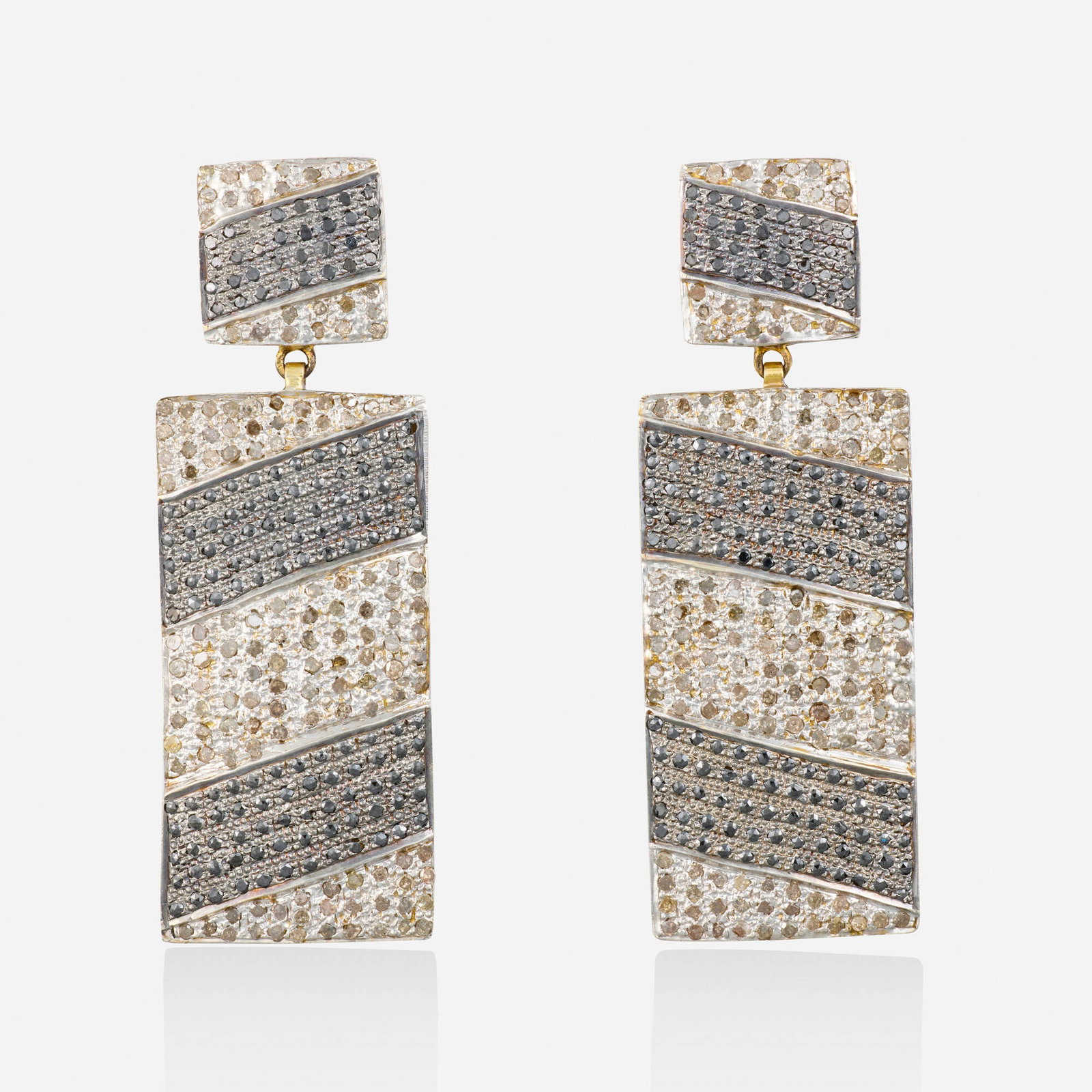 Diamond, silver, and gold earrigs: Diamond, silver, and gold earrigs Each set with stripes of rose-cut black diamonds and single-cut brown diamonds Silver, yellow gold 2.25 x 0.75 in; Gross weight 12.1 dwts This work will ship from Lam