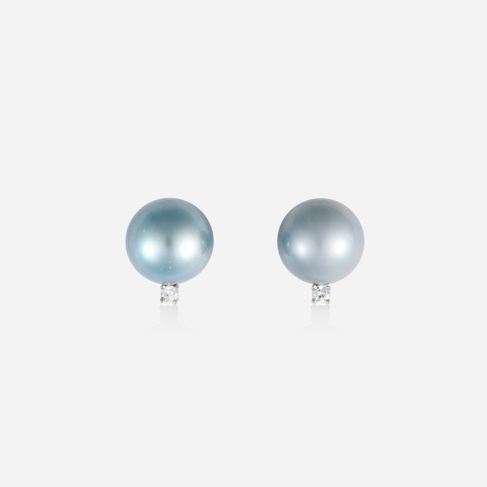 Grey cultured pearl, diamond, and white gold earrings: Grey cultured pearl, diamond, and white gold earrings Each set with a grey cultured pearl and round brilliant-cut diamond White gold 0.625 x 0.50 in; Gross weight 6.3 dwts This work will ship from Lam