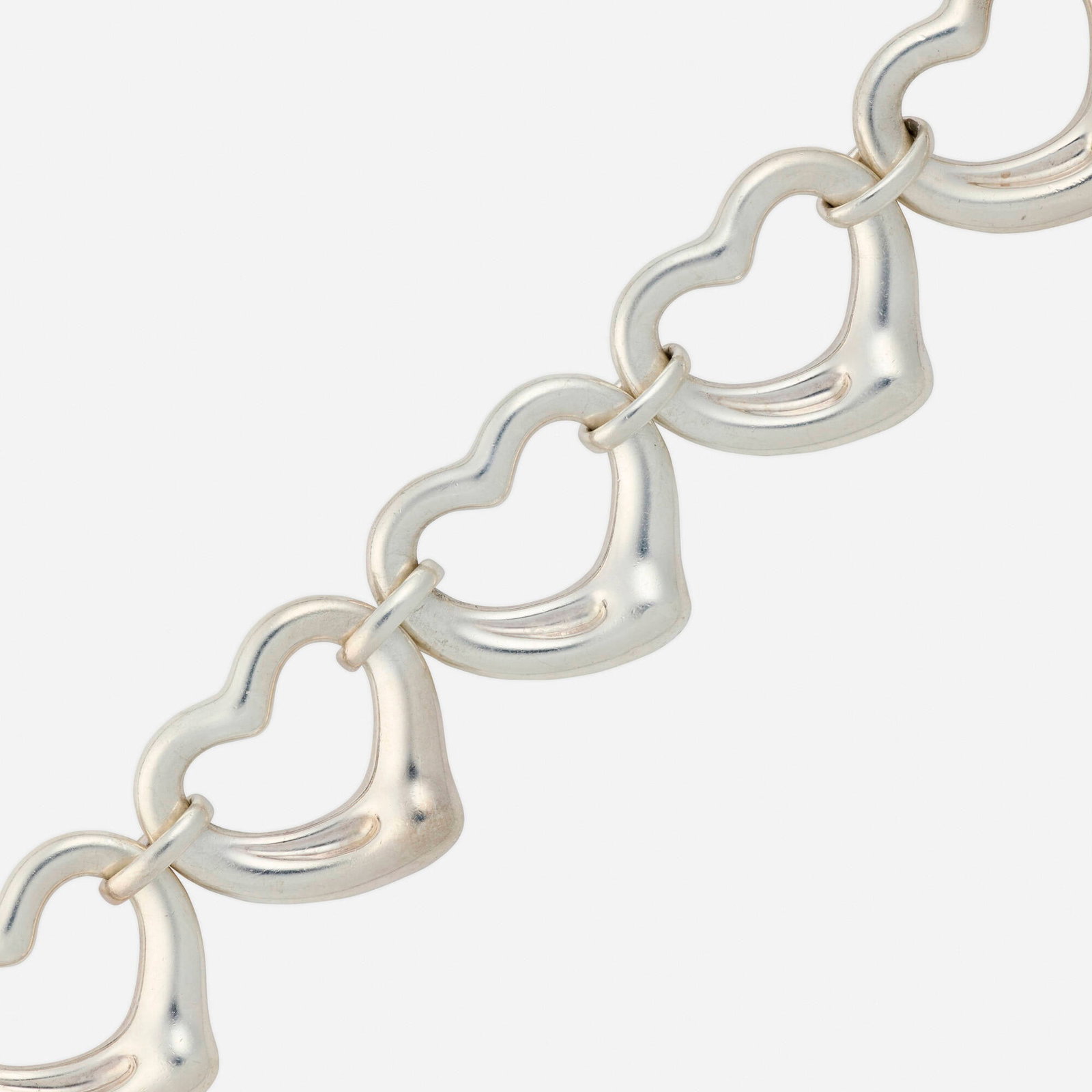 Elsa Peretti for Tiffany & Co., 'Open Heart' sterling silver bracelet: Elsa Peretti for Tiffany & Co. 'Open Heart' sterling silver bracelet Designed with five heart links Sterling silver Signed Tiffany & Co. Elsa Peretti 8.50 x 1.25 in; Gross weight 42.1 dwts Sold