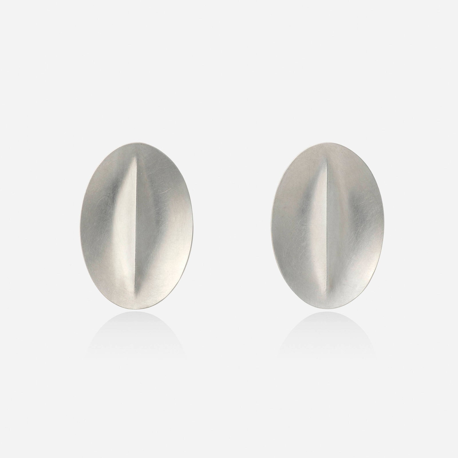 Niessing, Platinum earrings: Niessing Platinum earrings Each a concave oval Platinum Signed with maker's mark for Niessing 1.125 x 0.75 in; Gross weight 6.9 dwts This work will ship from Lambertville,