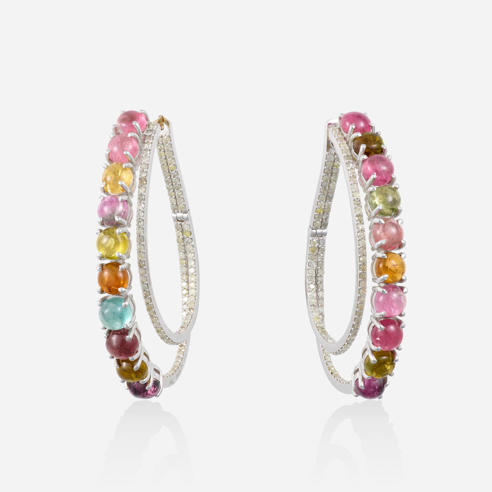 Multi-color tourmaline and diamond earrings: Multi-color tourmaline and diamond earrings Each an elongated hoop set in and out with multi-color tourmaline and single-cut diamonds Silver, yellow gold Approx. 1.75 x 0.25 in; Gross weight 8.8 dwts 