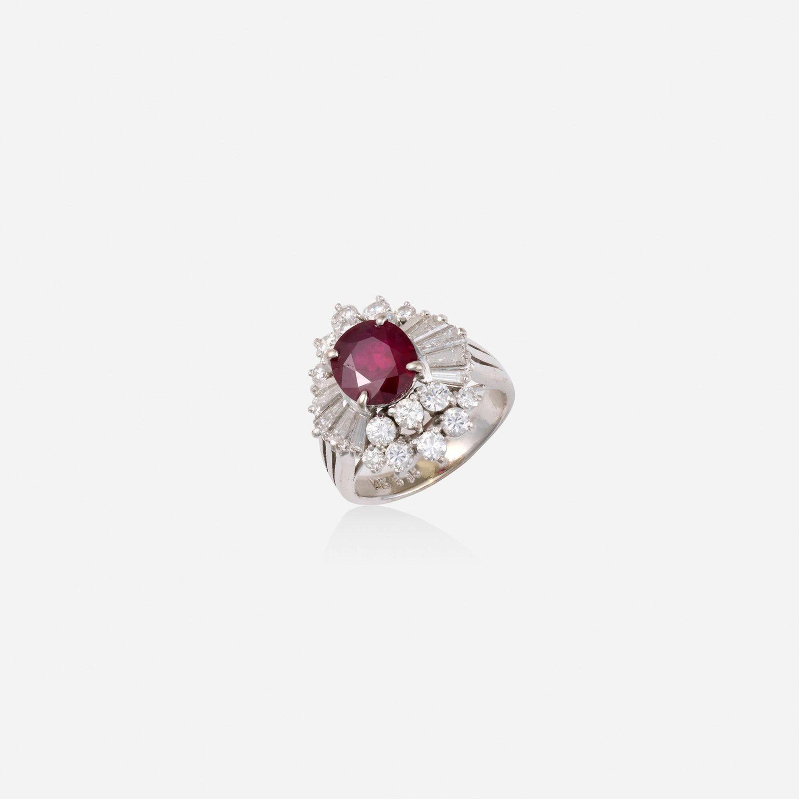 Ruby, diamond, and white gold ring: Ruby, diamond, and white gold ring Lori Ulanova was one of the first female violinists in the Los Angeles Philharmonic Set with an oval-cut ruby, surrounded by round brilliant and tapered baguette-cut