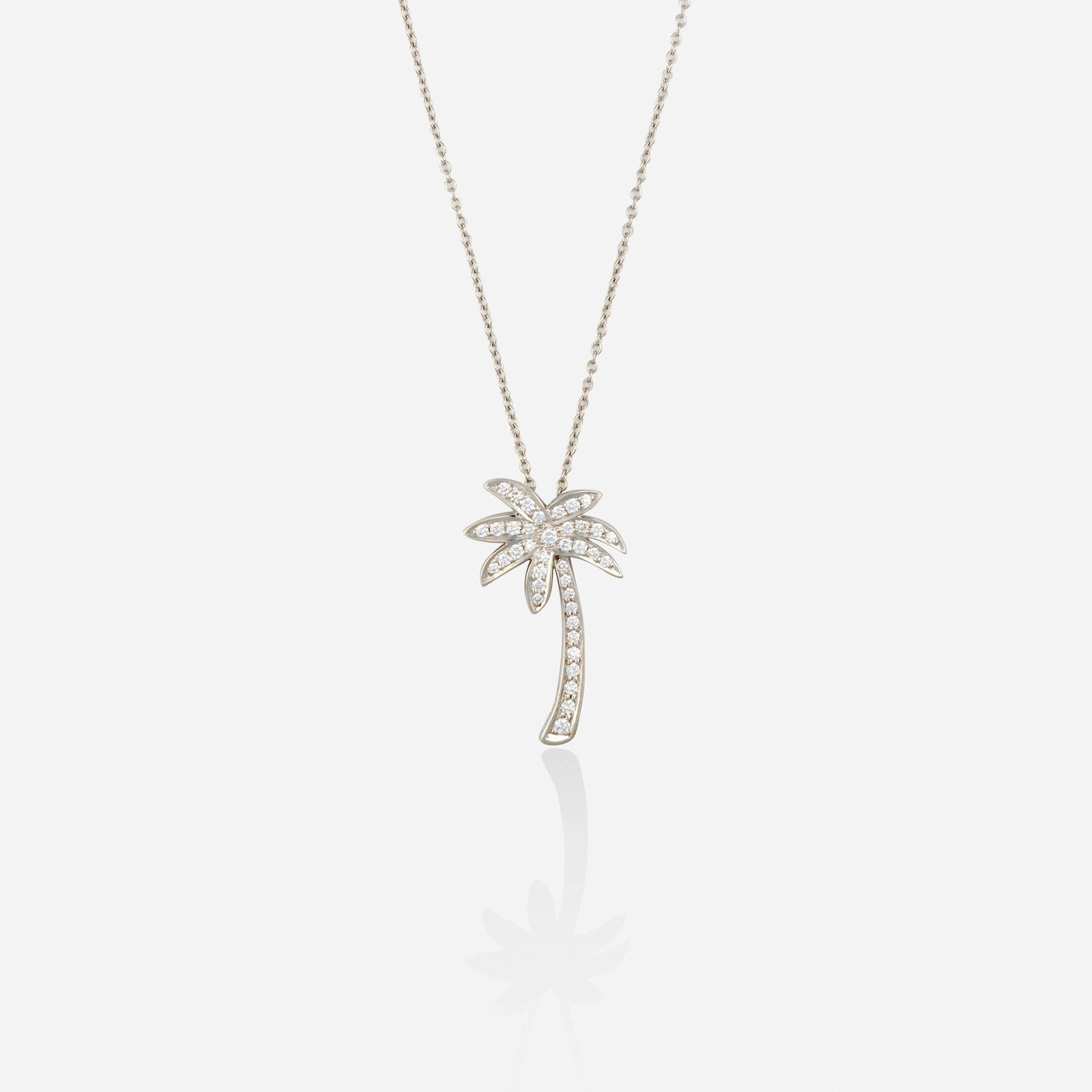 Tiffany & Co., Diamond and platinum necklace: Tiffany & Co. Diamond and platinum necklace Designed with a palm tree pendant set with round brilliant-cut diamonds, suspended from the fine link chain Platinum Signed Tiffany & Co. to necklace chain