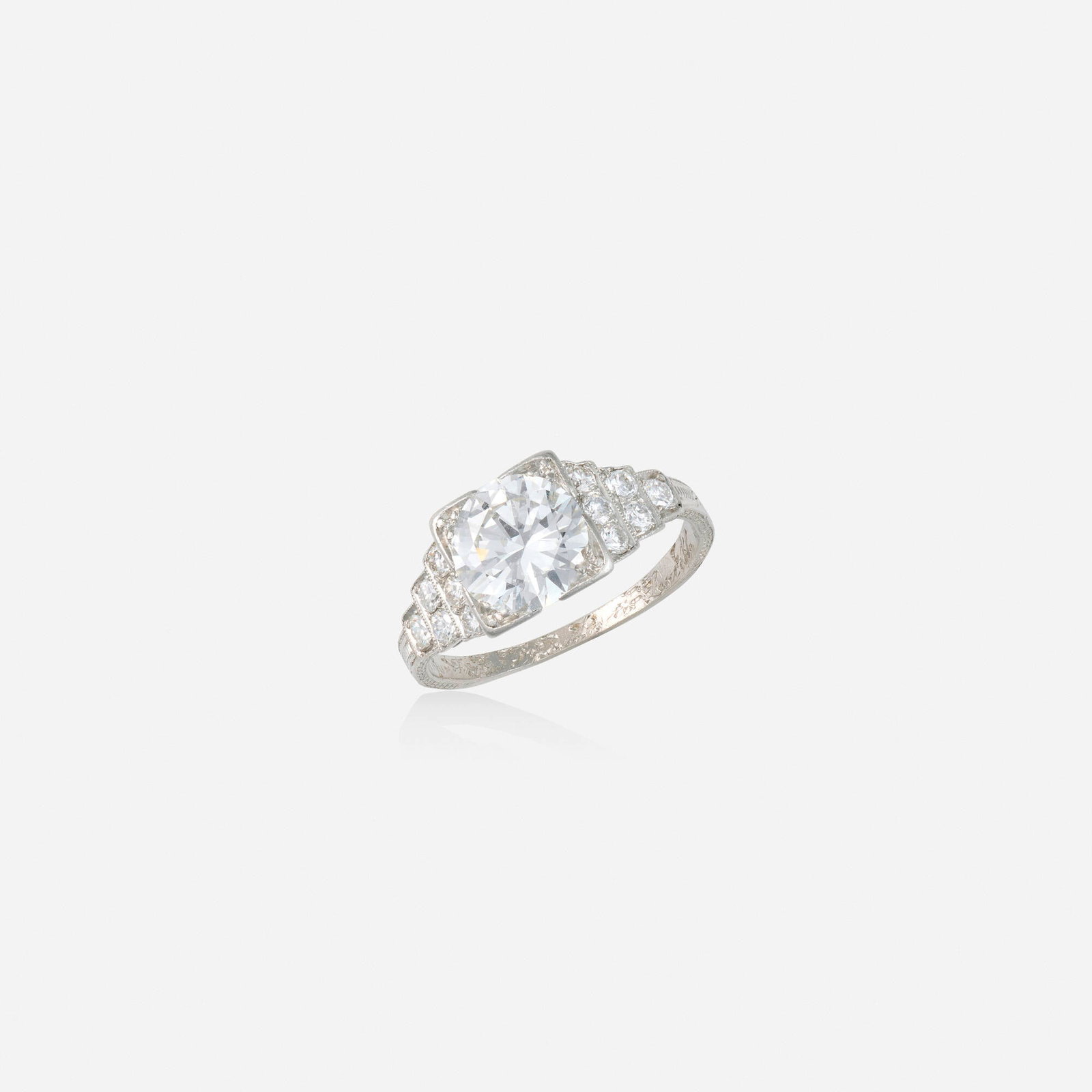 Diamond and platinum engagement ring: Diamond and platinum engagement ring Set with an old European-cut diamond, flanked by rows of round brilliant-cut diamonds Platinum Ring size 6.50; Gross weight 2.6 dwts This work will ship from Lambe