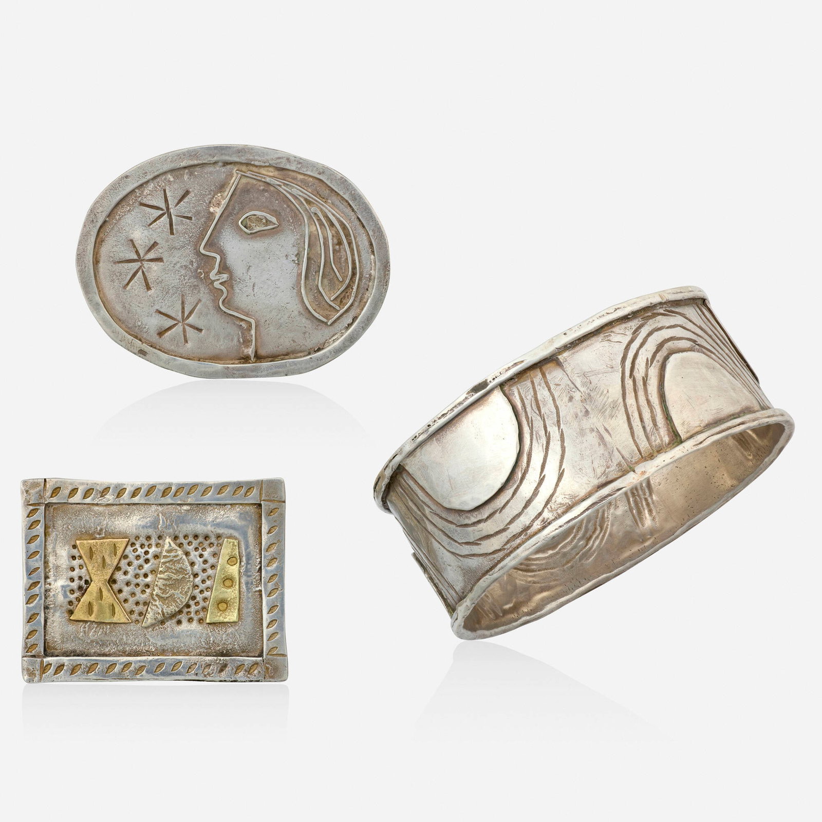 Breon O'Casey, Group of silver jewelry: Breon O'Casey Group of silver jewelry Each of abstract design, the oval brooch inspired by the works of Picasso, 1986, the rectangular brooch of three figures, and the bangle bracelet of mountains Sil