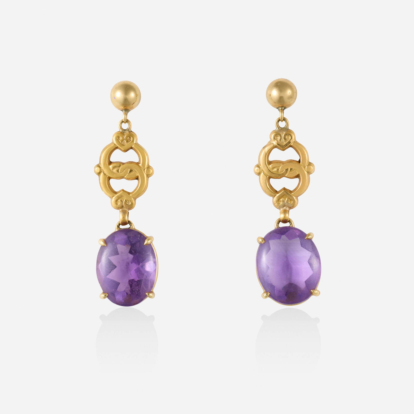 Amethyst and gold earrings: Amethyst and gold earrings Each designed with interlocked hearts and set with a buff top-cut amethyst 14k yellow gold 1.625 x 0.50 in; Gross weight 4.4 dwts Provenance: Collection of Mari Shaw