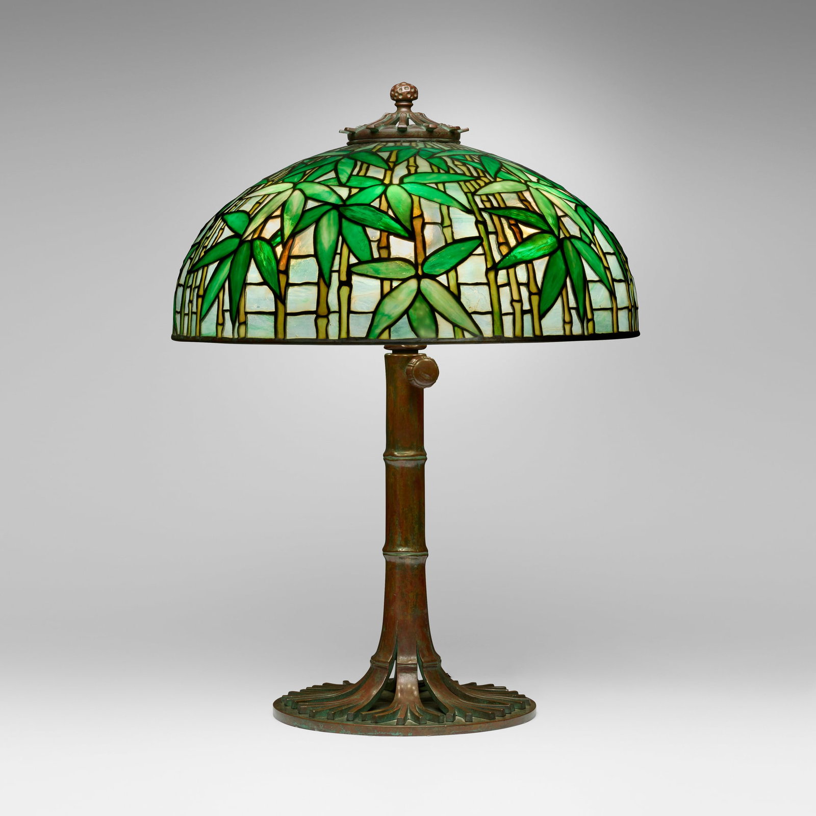 Tiffany Studios, Rare Bamboo table lamp: Tiffany Studios Rare Bamboo table lamp USA, c. 1910 leaded glass, patined bronze 29.5 h x 22 dia in (75 x 56 cm) Lamp features an adjustable Bamboo Library base. Impressed to shade 'TIFFANY STUDIOS