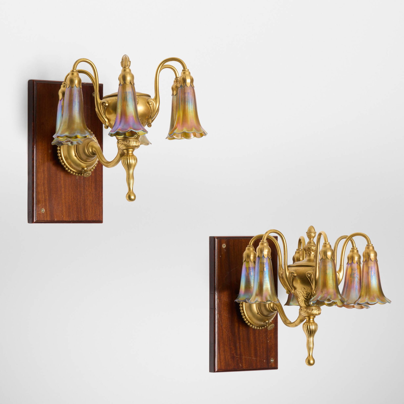 Tiffany Studios, Six-light Lily sconces, pair: Tiffany Studios Six-light Lily sconces, pair USA, c. 1910 gilt bronze, hand-blown Favrile glass 12 h x 12.5 w x 13.5 d in (30 x 32 x 34 cm) Etched to six shades 'L.C.T. Favrile' and t