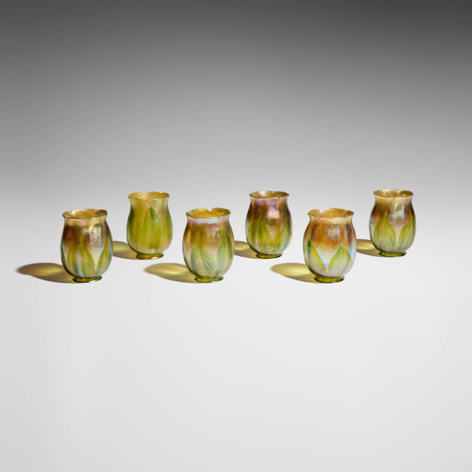 Tiffany Studios, Collection of six pulled-feather tulip shades: Tiffany Studios Collection of six pulled-feather tulip shades USA, c. 1910 hand-blown Favrile glass 4.875 h x 3.5 dia in (12 x 9 cm) Etched to rim of five examples 'L.C.T.' and to one